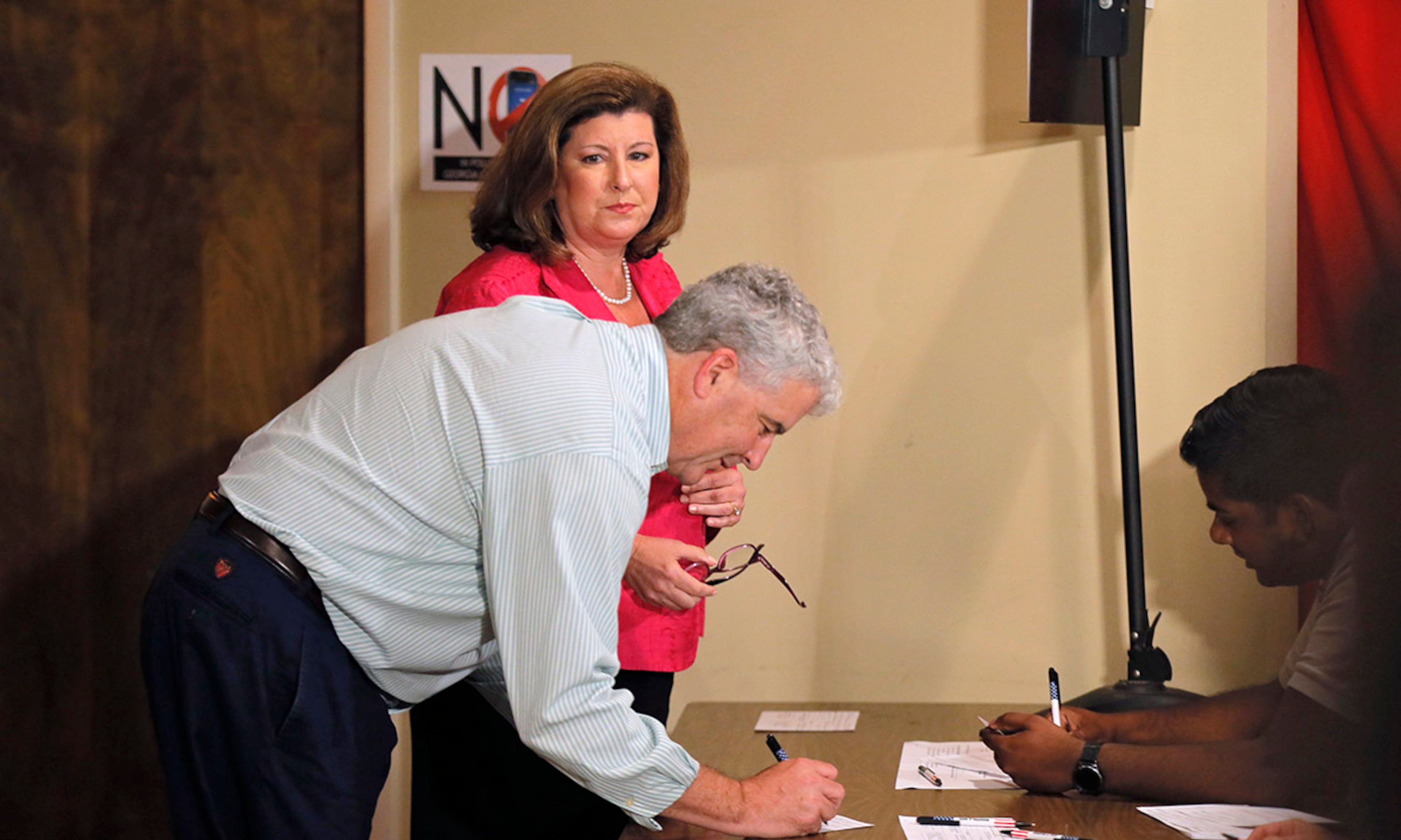6/20/17 - Roswell, GA - Karen Handel, candidate for Congress, waits while her husband, Steve, completes his voter form. They voted in the 6th District Special Election at St Mary's Orthodox Church in Roswell, GA. BOB ANDRES /BANDRES@AJC.COM