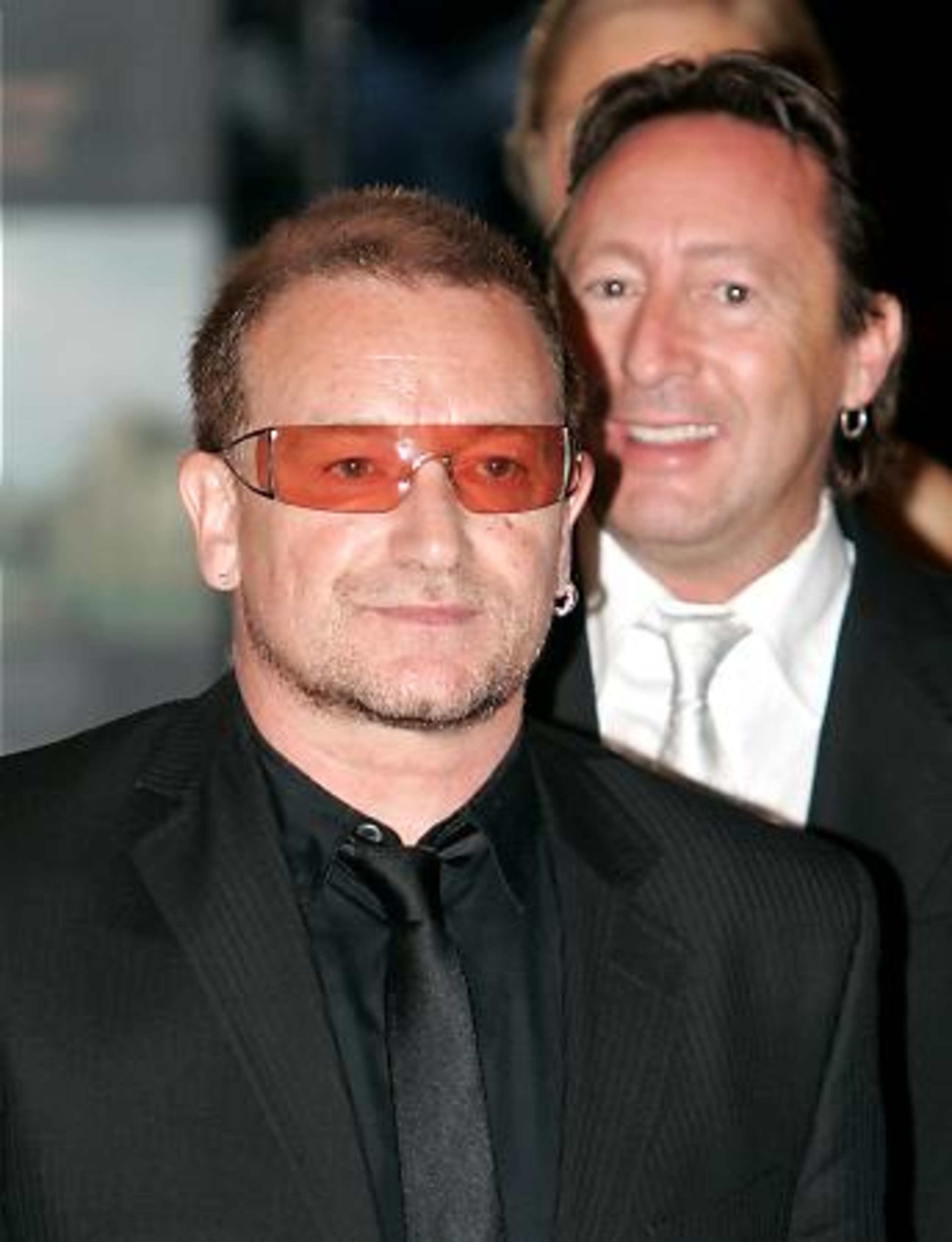 Bono, with Julian Lennon in the background