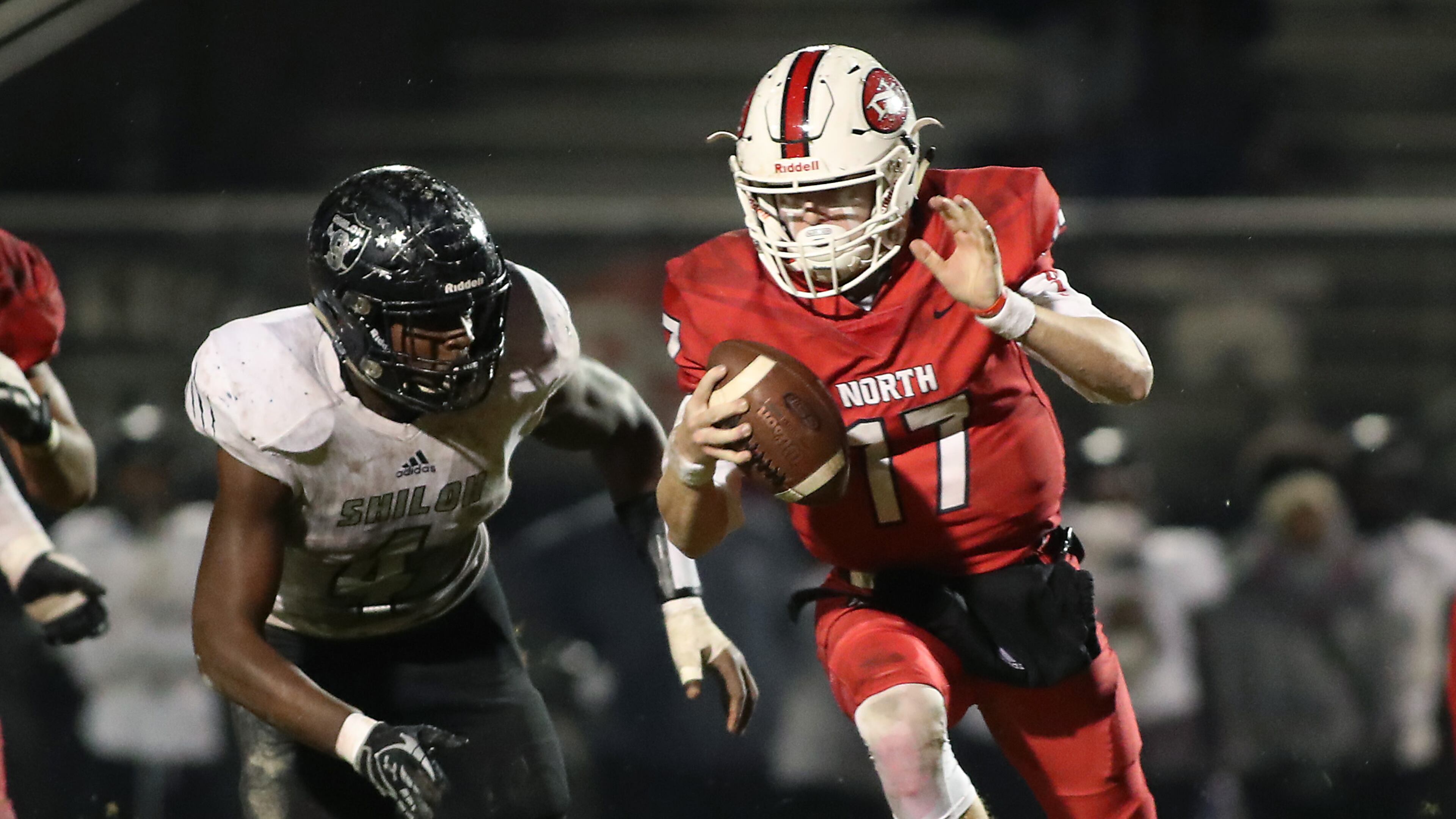 North Gwinnett quarterback JR Martin (17) rushes against Shiloh defensive end Jasheen Davis (4) in the second quarter of Friday's game. (Jason Getz/Special)