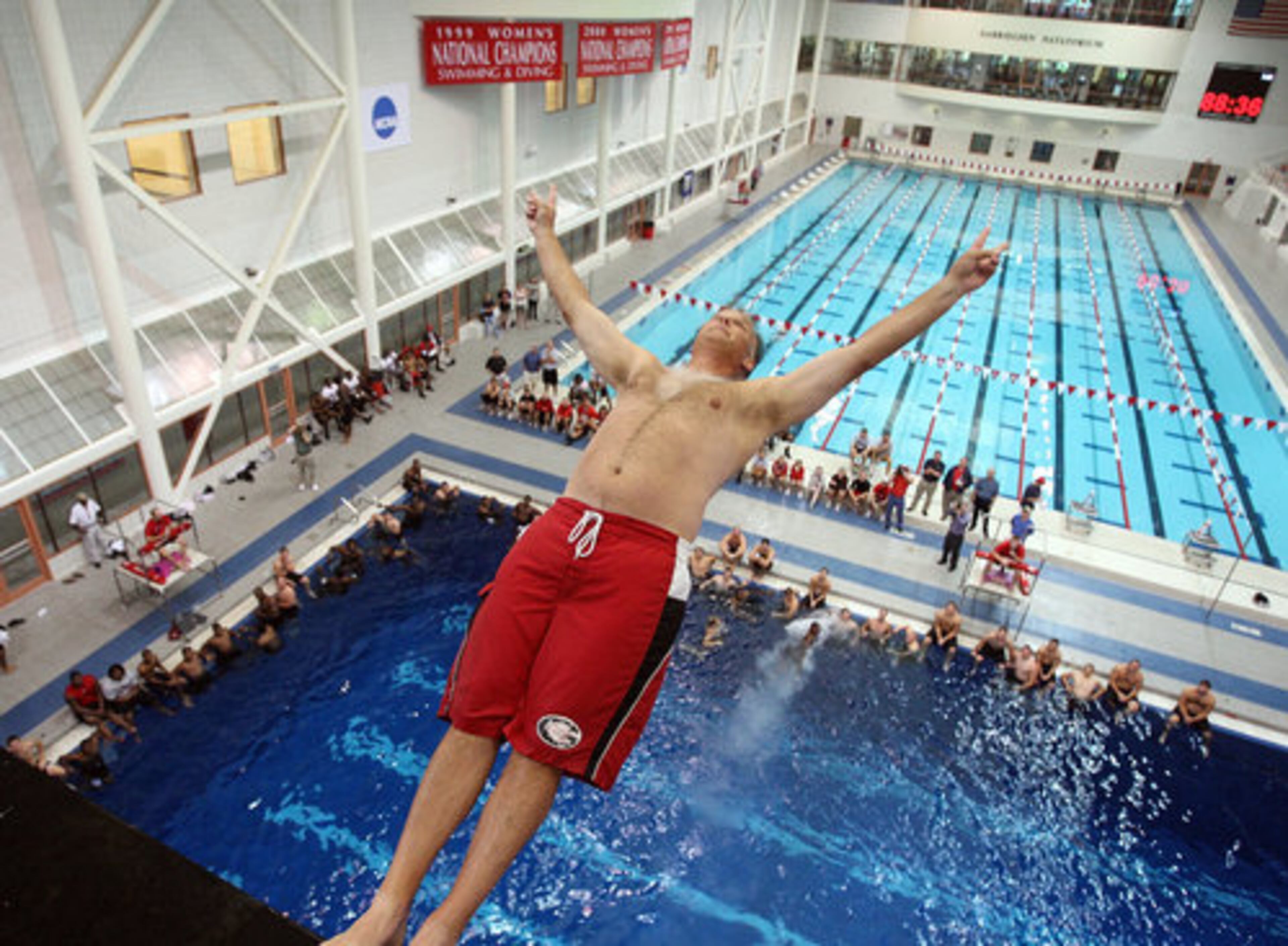 UGA Bulldog head football coach Mark Richt dives off the 10-meter platform in Athens on Wednesday. Richt surprised his players by cancelling morning practice and taking them to the Ramsey Student Center instead for aquatic adventures.