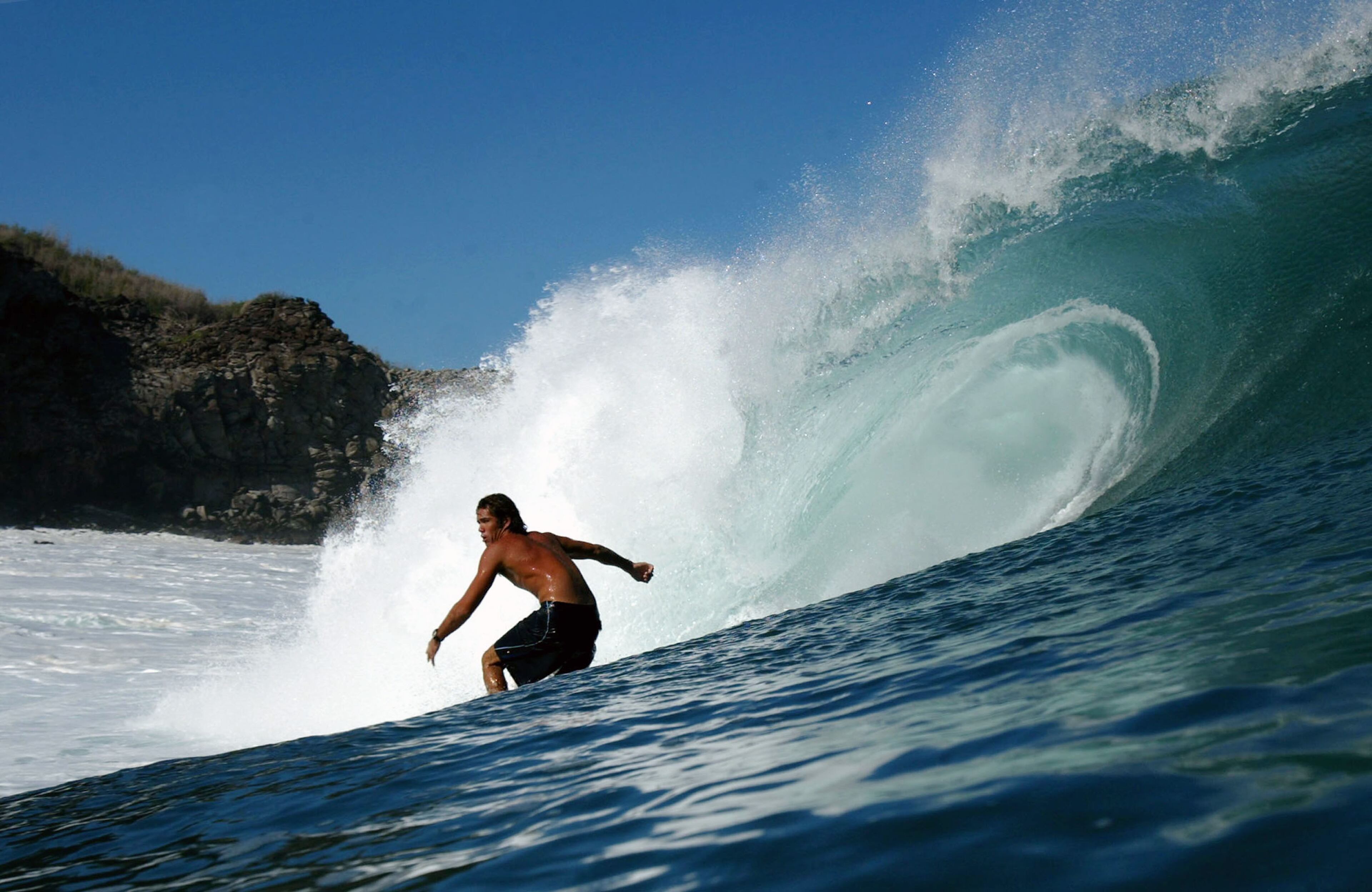 KAPALUA, HAWAII - JANUARY 10: Surfer Chris Stor drops into a large wave during a large swell on January 10, 2004 at Windmills in Kapalua, Maui, Hawaii. (Photo by Donald Miralle/Getty Images)