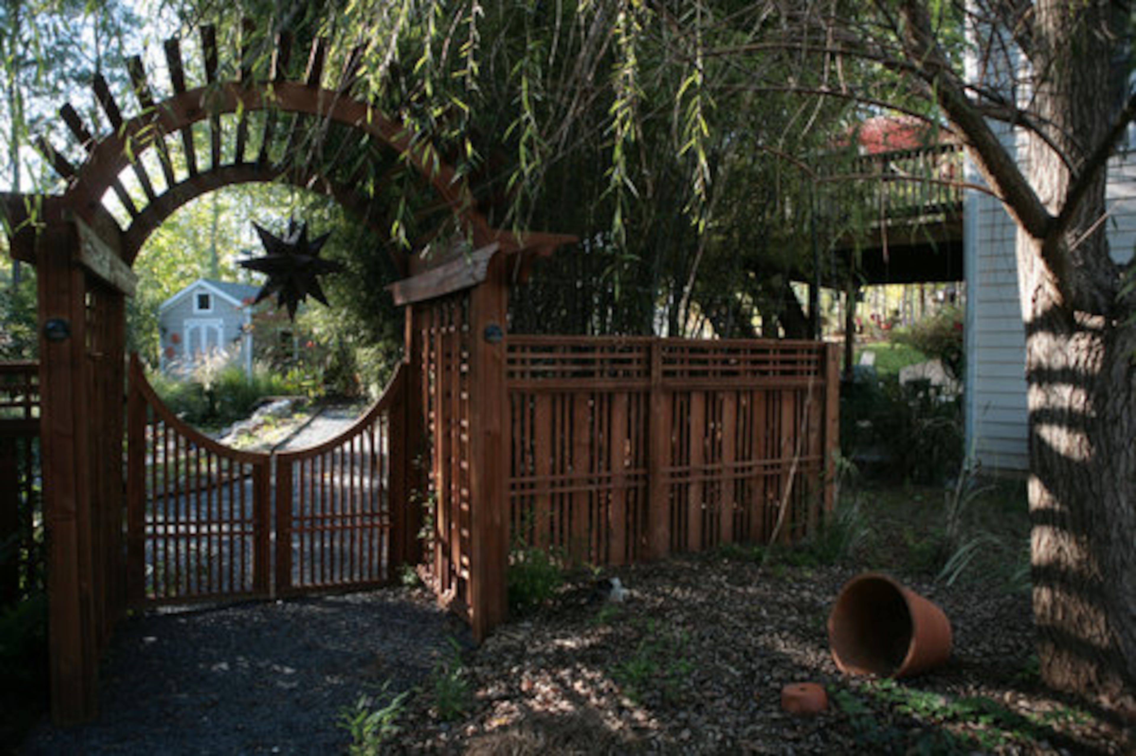 Visitors enter her backyard oasis through an artful circular arbor. Wanting a Japanese-inspired look, McCraw worked with a contractor to create the right shape. "I kept telling him 'No, it can't be the shape of a football,'" she said. "It has to be zen."