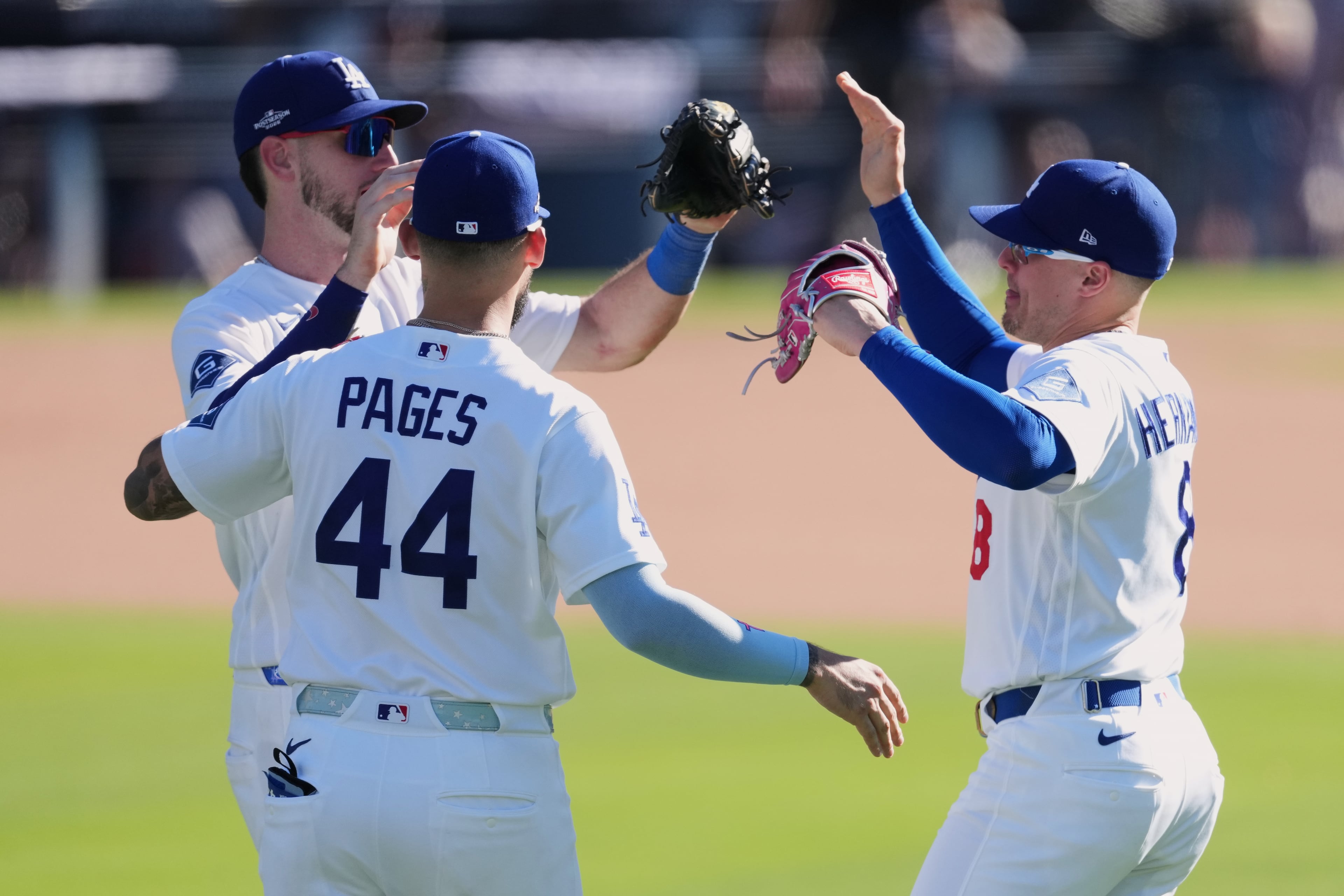 Los Angeles Dodgers left fielder Kiké Hernández (right) celebrates with center fielder Andy Pages (second from left) and right fielder Kyle Tucker (left) after the Dodgers defeated the Atlanta Braves 5-3 in Game 1 of a National League Division Series baseball game Saturday, Oct. 3, 2026, in Los Angeles. (Jae C. Hong/AP)