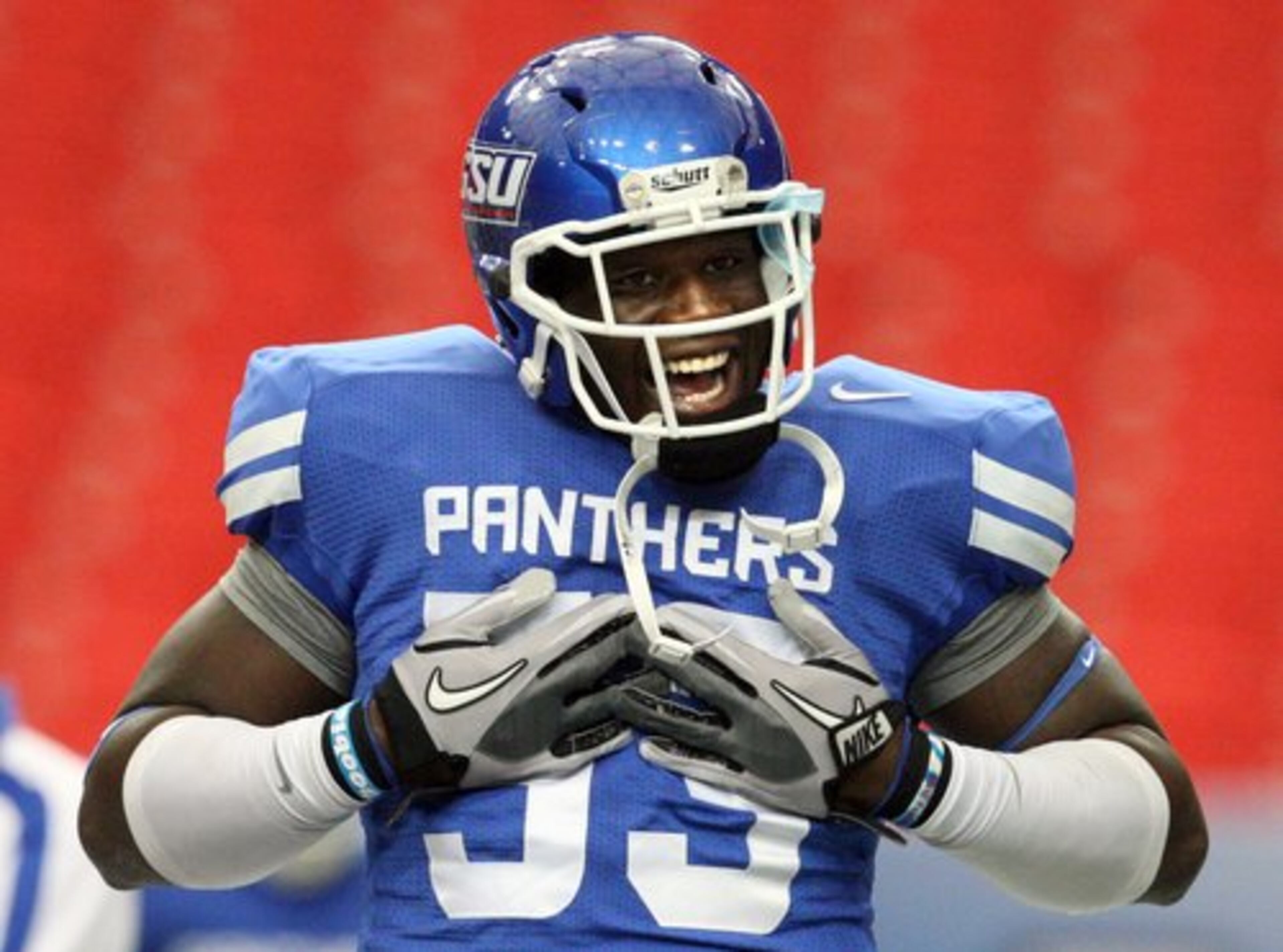 Defensive tackle Christo Bilukidi appears intense as he gets his teammates fired up before the game.