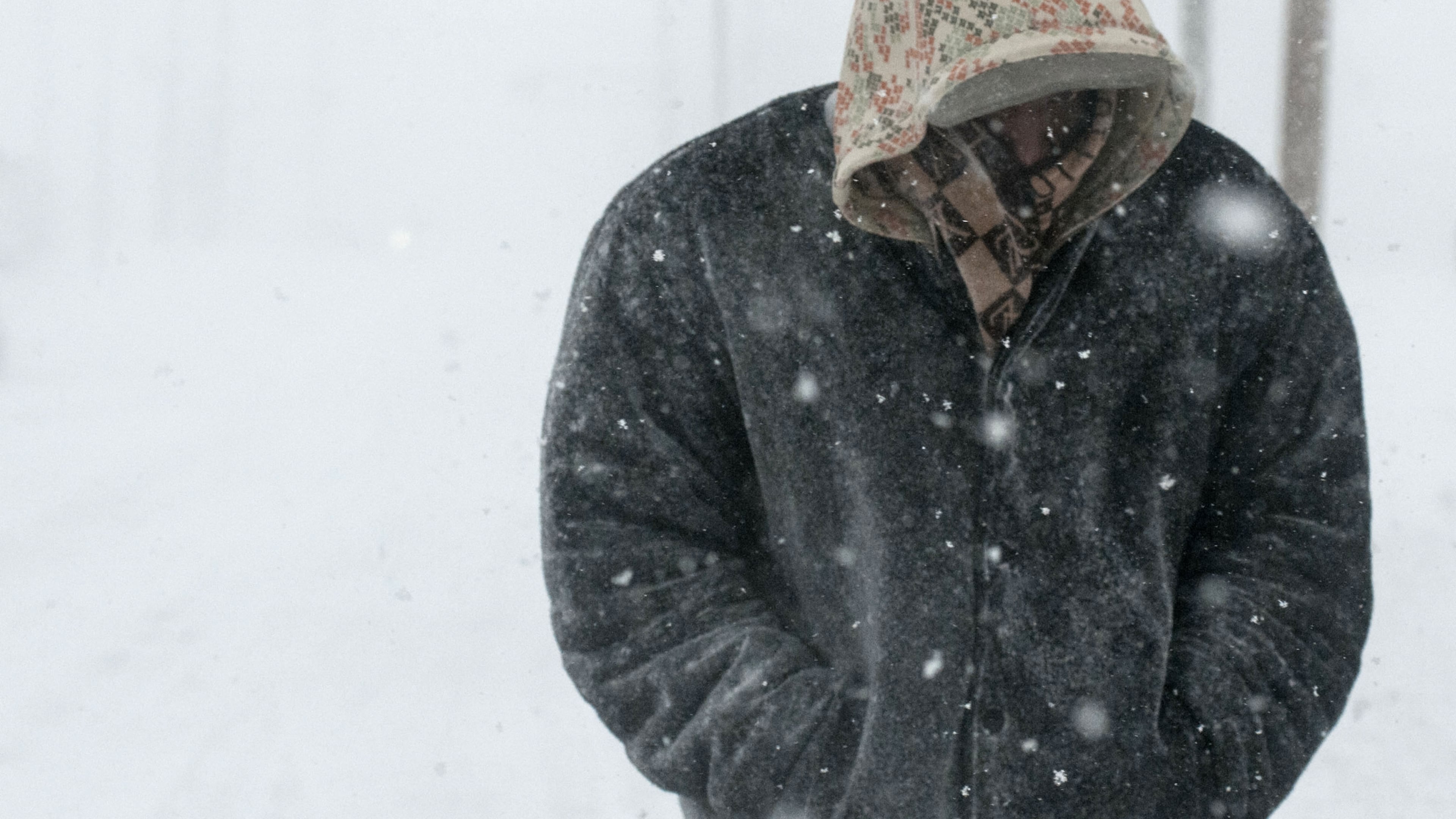Tyron Smith tries to keep warm as he walks down Bradley Avenue in Champaign, Ill., Sunday Jan. 5, 2014. Icy, snow-covered roads and high winds made travel treacherous from the Dakotas and Michigan to Missouri as much of the nation braced for the next winter wallop: a dangerous cold that could break records. (AP Photo/The News-Gazette, Holly Hart)