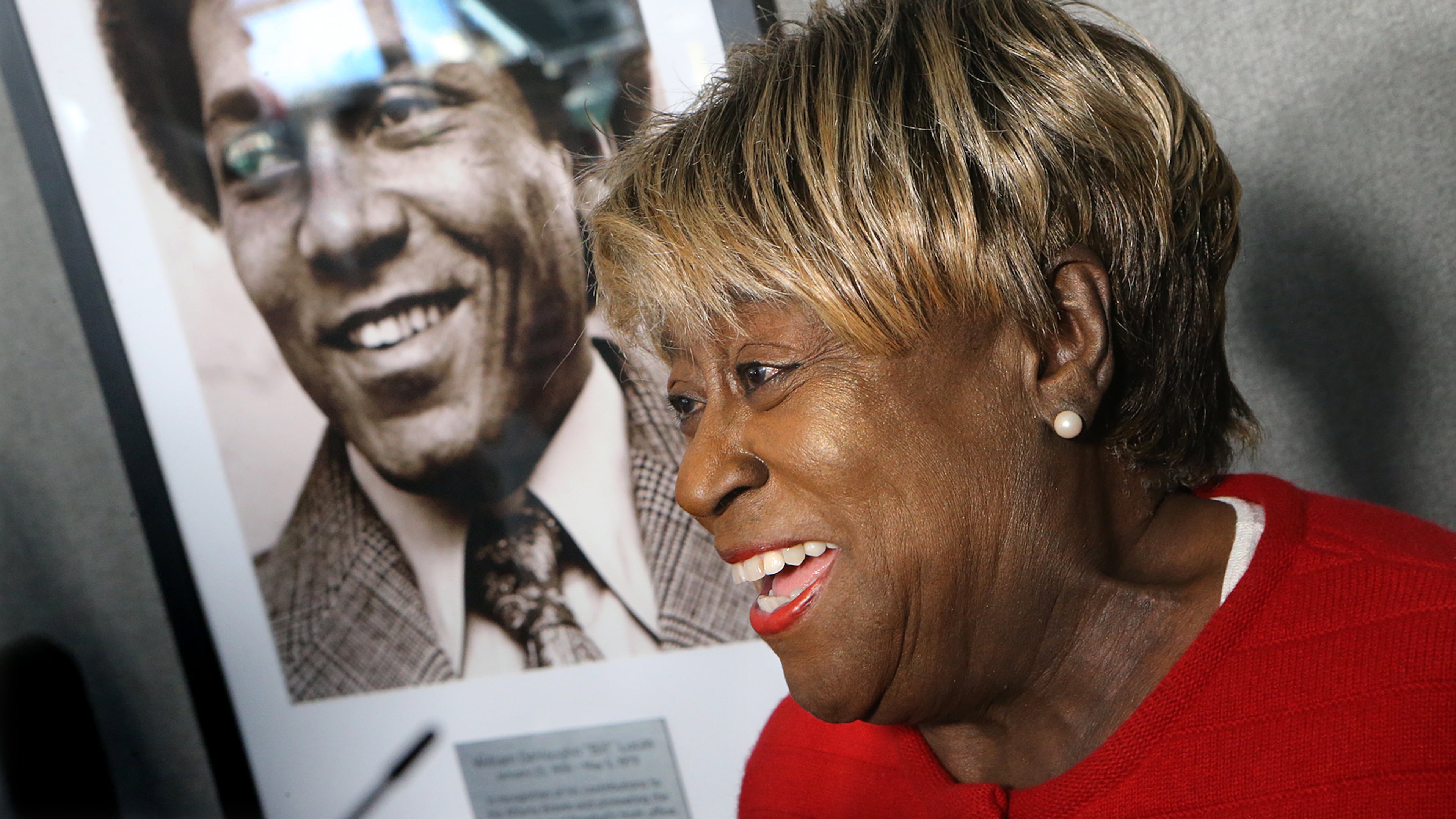 Rubye Lucas, widow of Bill Lucas, speaks next to his portrait during a ceremony naming the Braves' baseball operations conference room after Lucas, baseball's first Black general manager, in 2017. The dedication coincided with the 40th anniversary of Lucas' first season as Atlanta's vice president of player personnel. (Curtis Compton/AJC 2017)