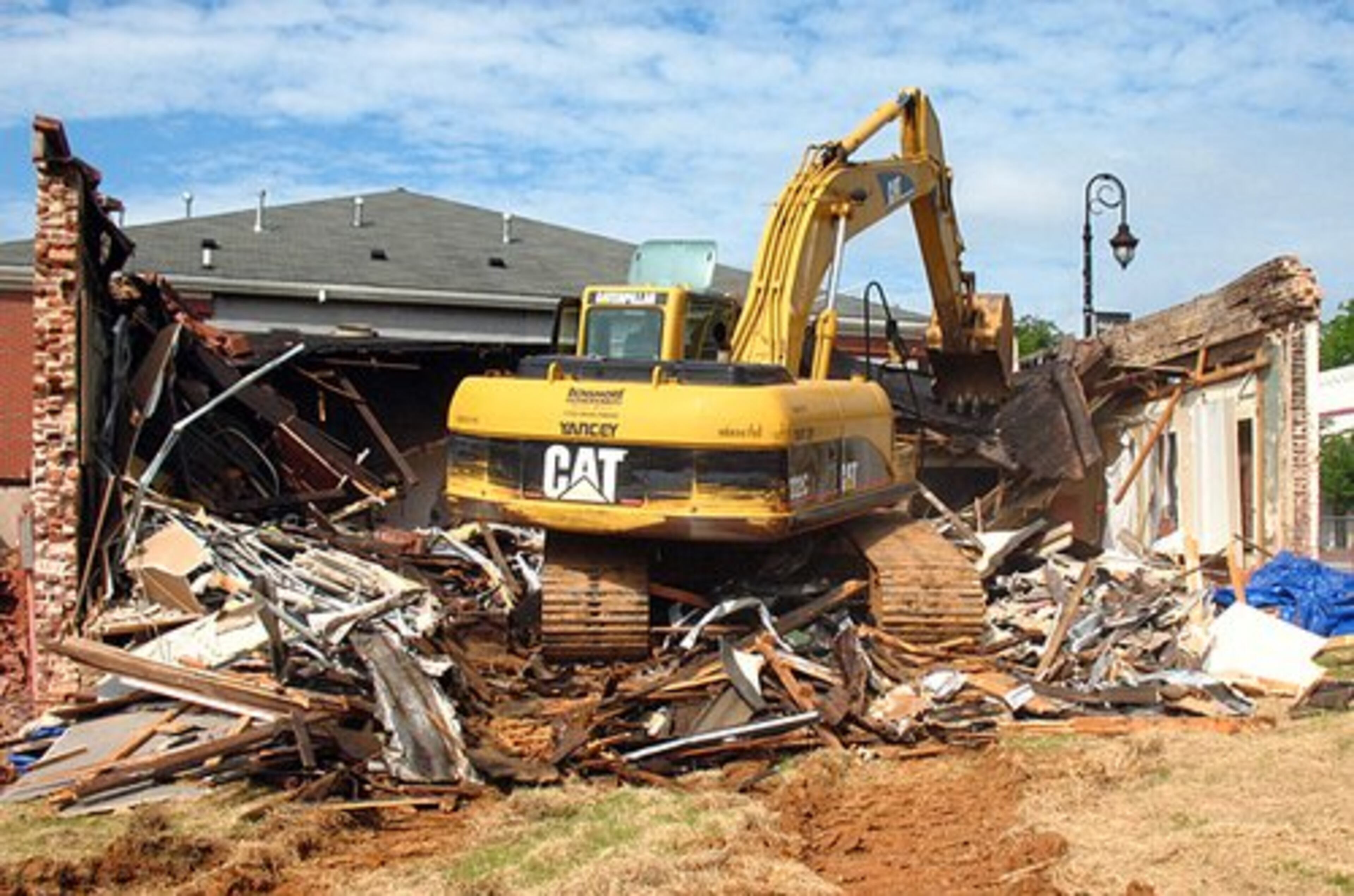 Work crews spend about an hour Wednesday morning leveling the oldest portion of Duluth's prized Red Clay Theatre.