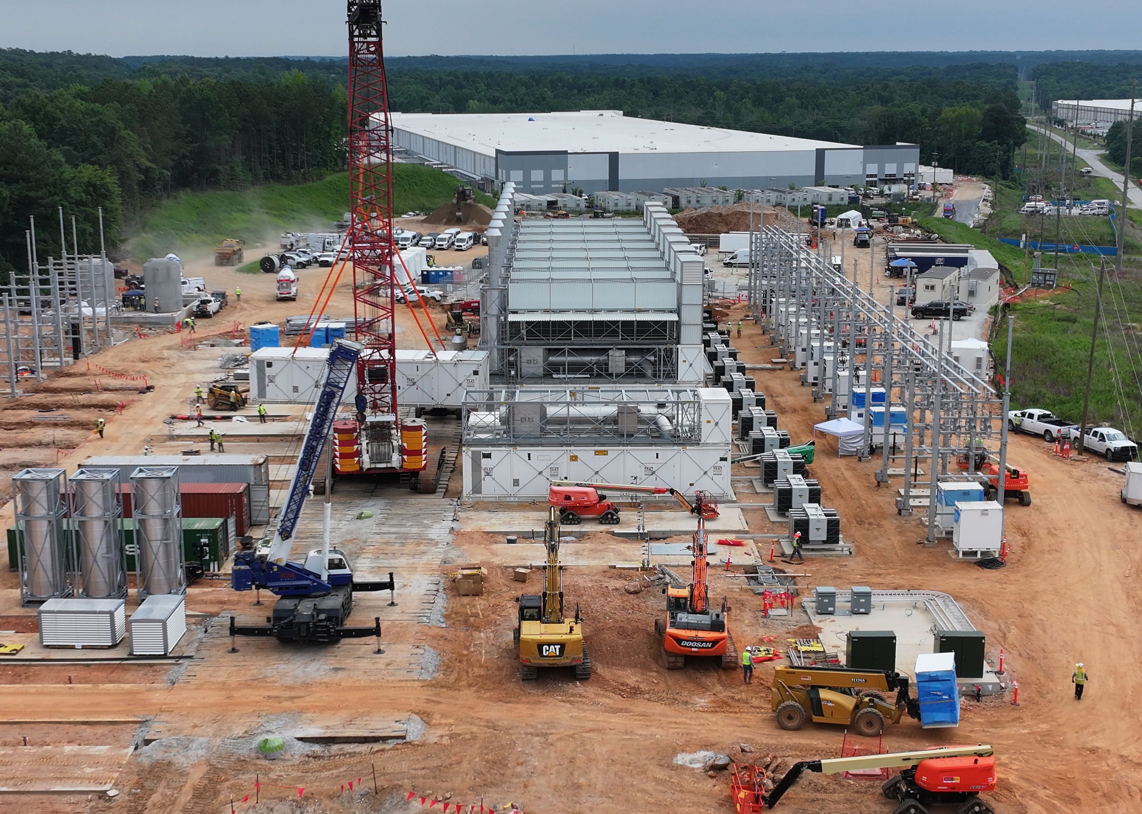 Aerial view of off-grid generators being installed, with the data center in the background, in Covington in June. (Hyosub Shin/AJC)