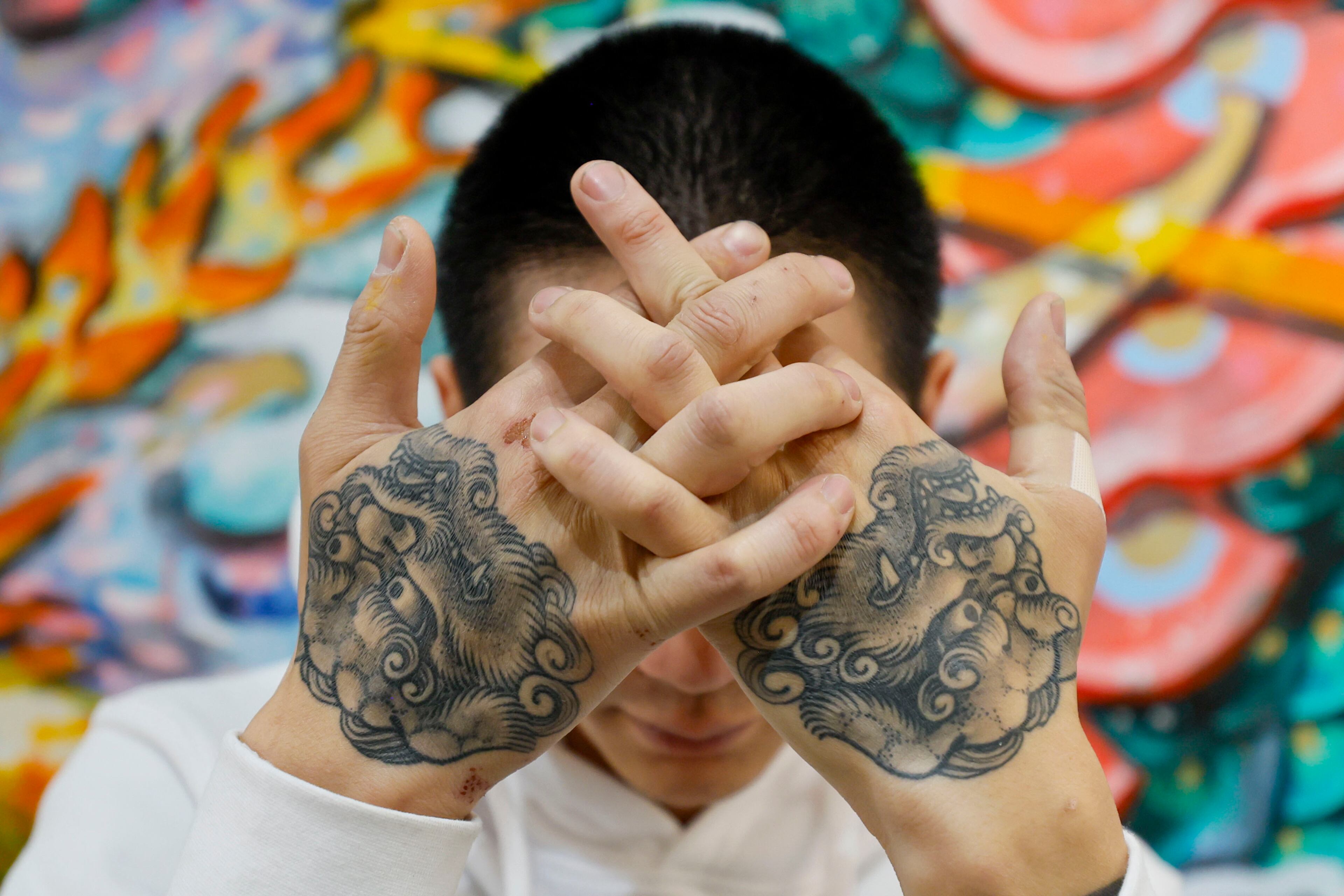 While a student at UGA, Andrew Blooms was inspired by library book about the art of Japanese tattoos. Now, he says he can’t count how many tattoos he has because they are done individually and then link up. (Miguel Martinez/AJC)