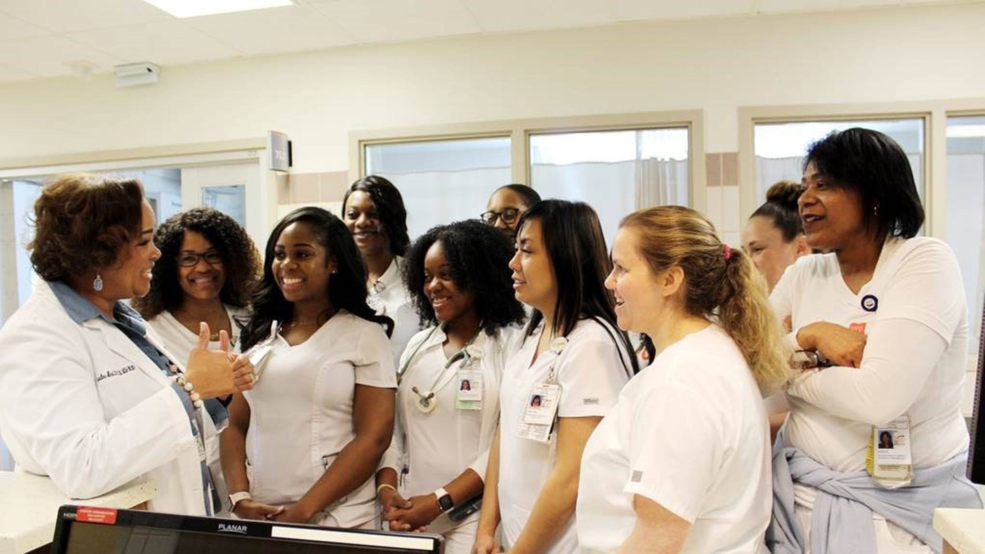Jacqueline Herd (left), chief nursing officer at Grady Memorial Hospital, holds an informal briefing with nurses in the hospital’s intensive care unit. CONTRIBUTED