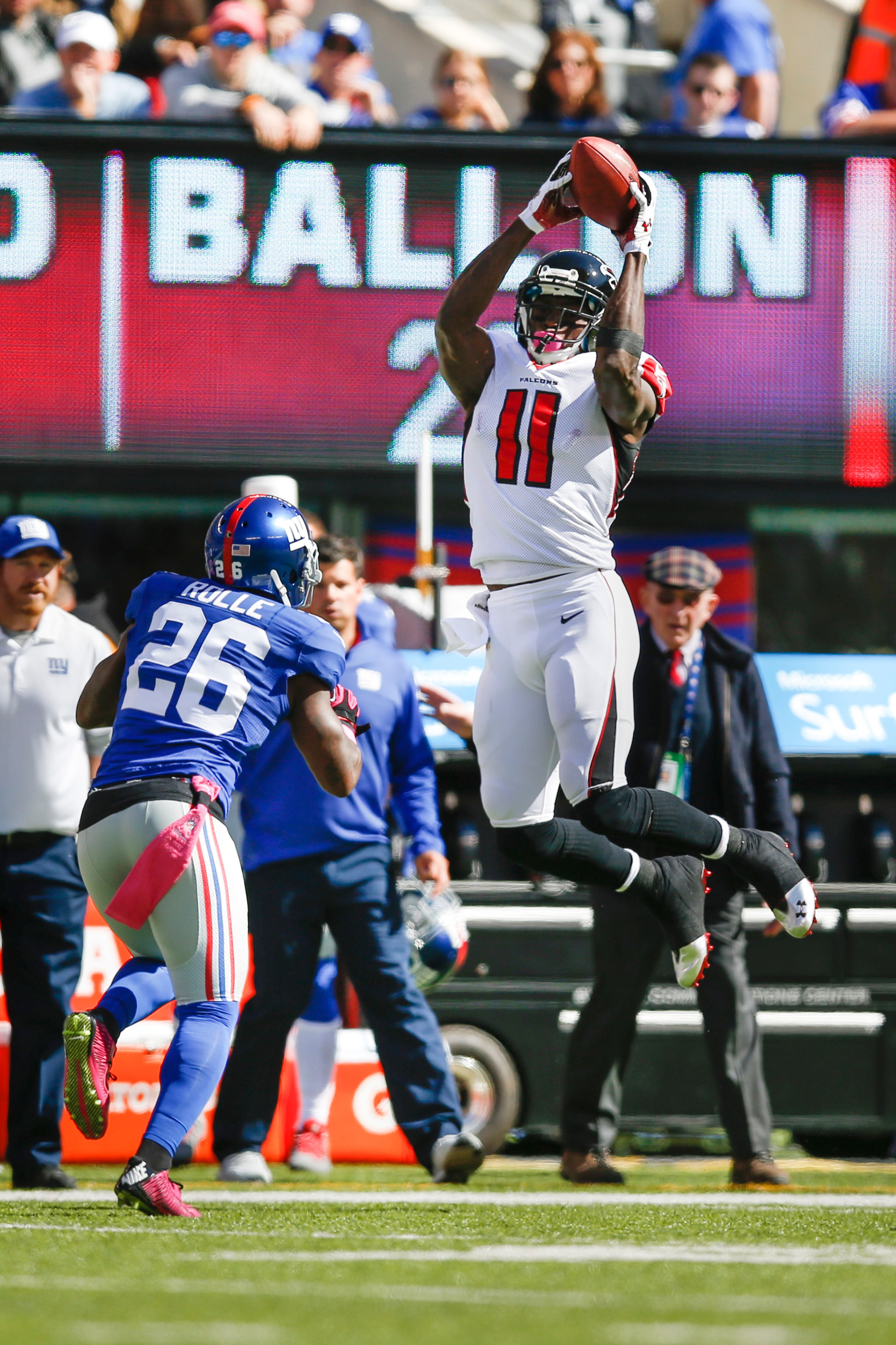Atlanta Falcons wide receiver Julio Jones (11) makes a catch as New York Giants strong safety Antrel Rolle (26) defends on the play during the first half of an NFL football game, Sunday, Oct. 5, 2014, in East Rutherford, N.J. (AP Photo/Kathy Willens)