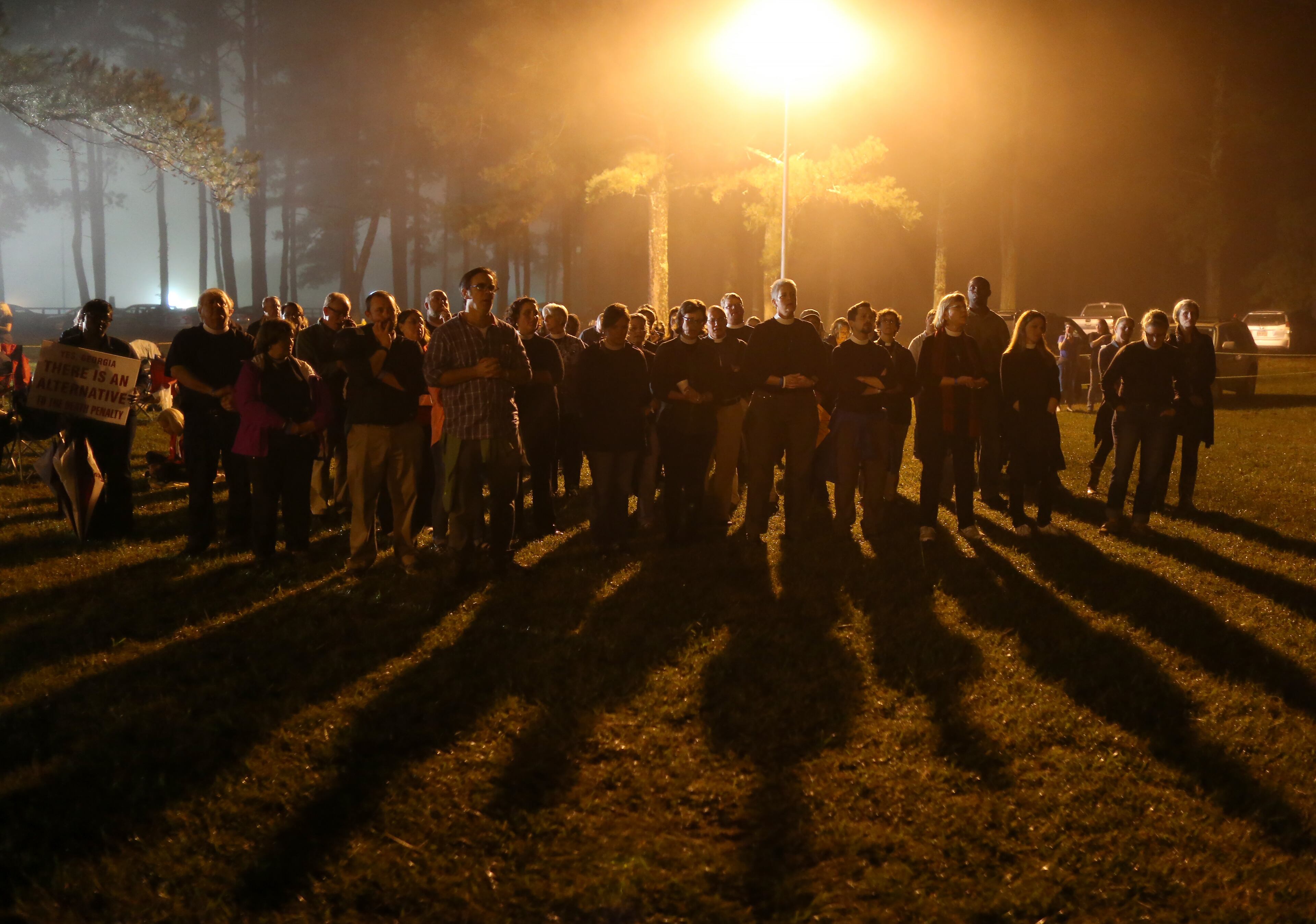 Protesters sing songs into the night outside of Georgia Diagnostic Prison in Jackson on Tuesday evening September 29, 2015, before the scheduled execution of Kelly Gissendaner. Ben Gray / bgray@ajc.com