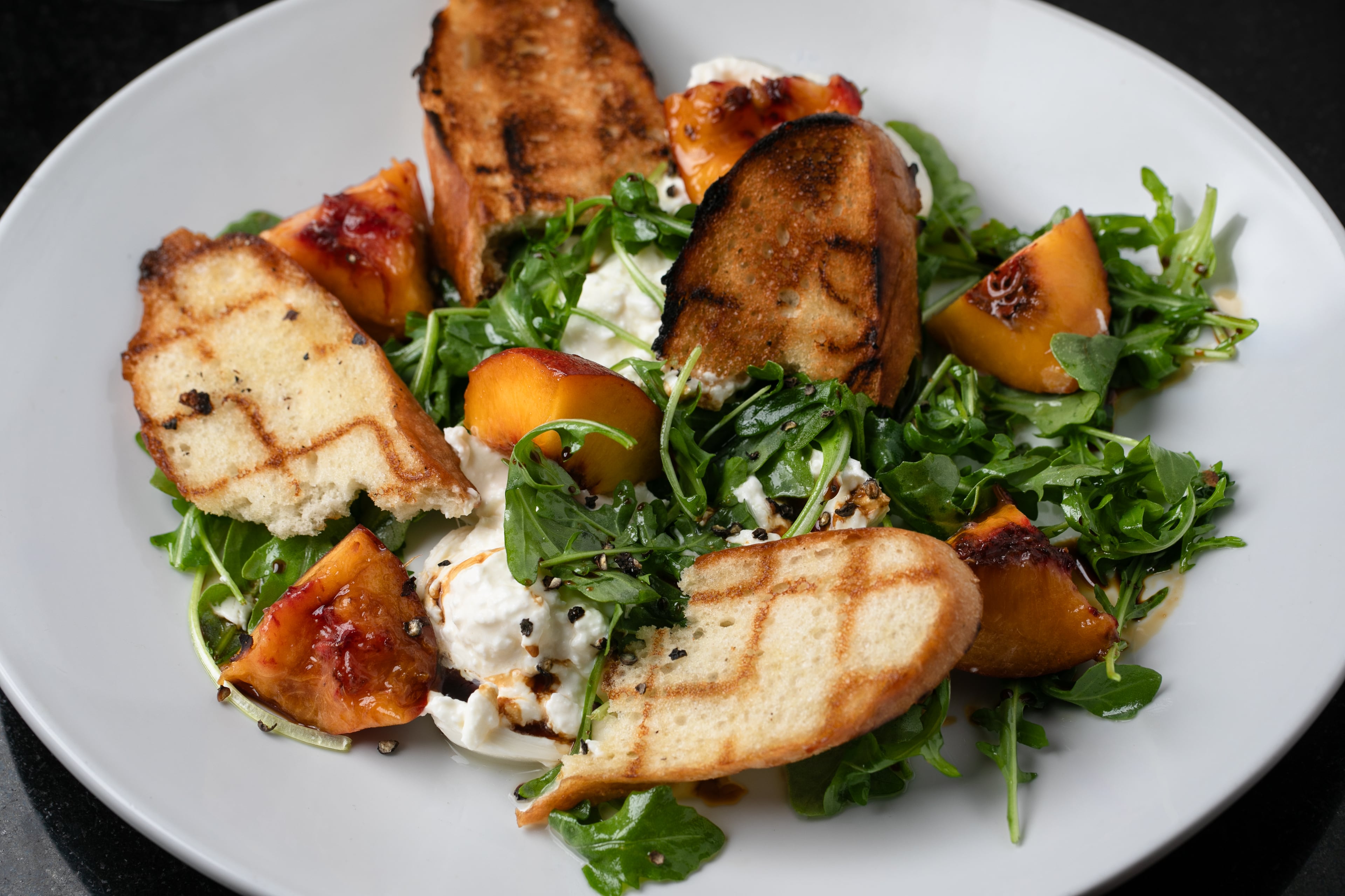 A seasonal burrata salad made with peaches at McKendrick's. (Erik Meadows Photography/Courtesy of McKendrick's Steakhouse & Bar)