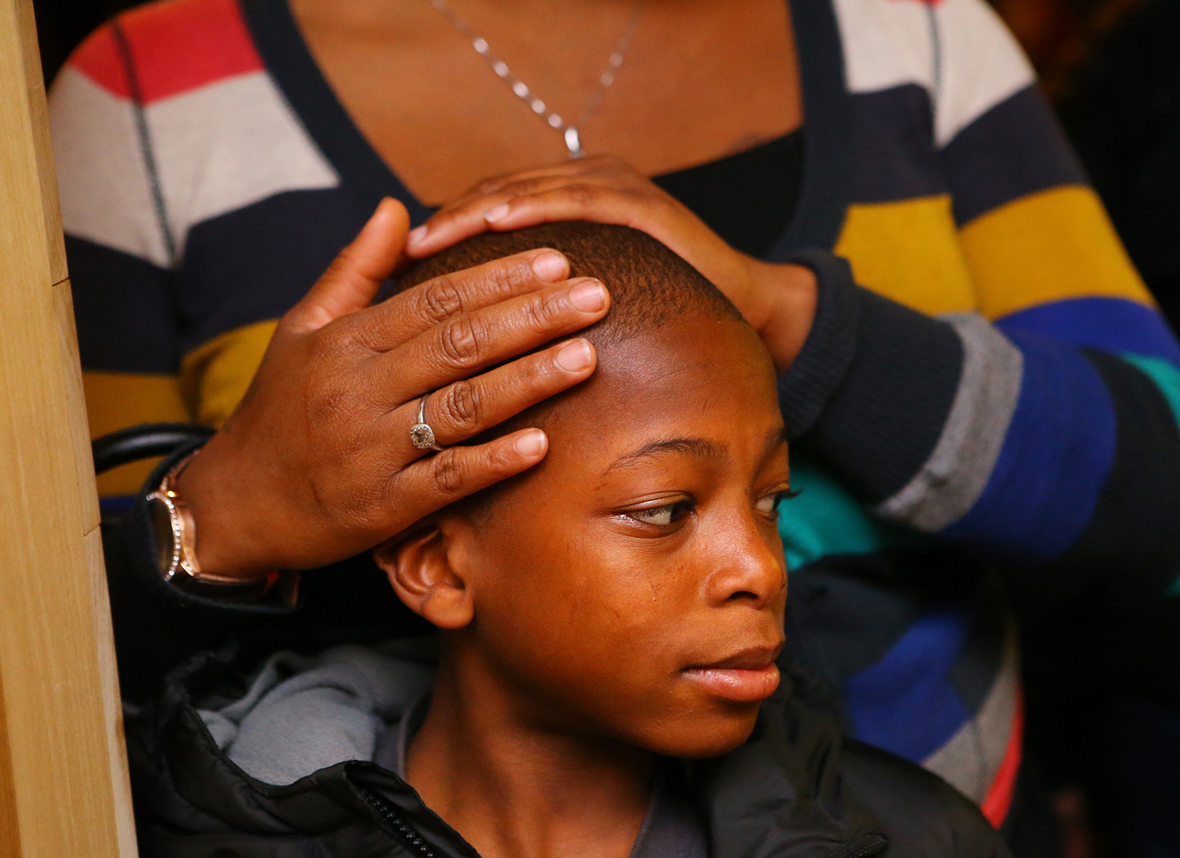Cortez Willis, 11, and his mother Amelia Mitchell, Atlanta, wait in line for a toy from Jeezy as he hosts 200 needy inner city kids from Macon, Hawkinsville, and Atlanta for Christmas on Monday, Dec. 22, 2014, in Atlanta. The children were treated to a private screening of the movie Annie, followed by food and toys given out by "Santa Jeezy" at Gio's. Curtis Compton / ccompton@ajc.com