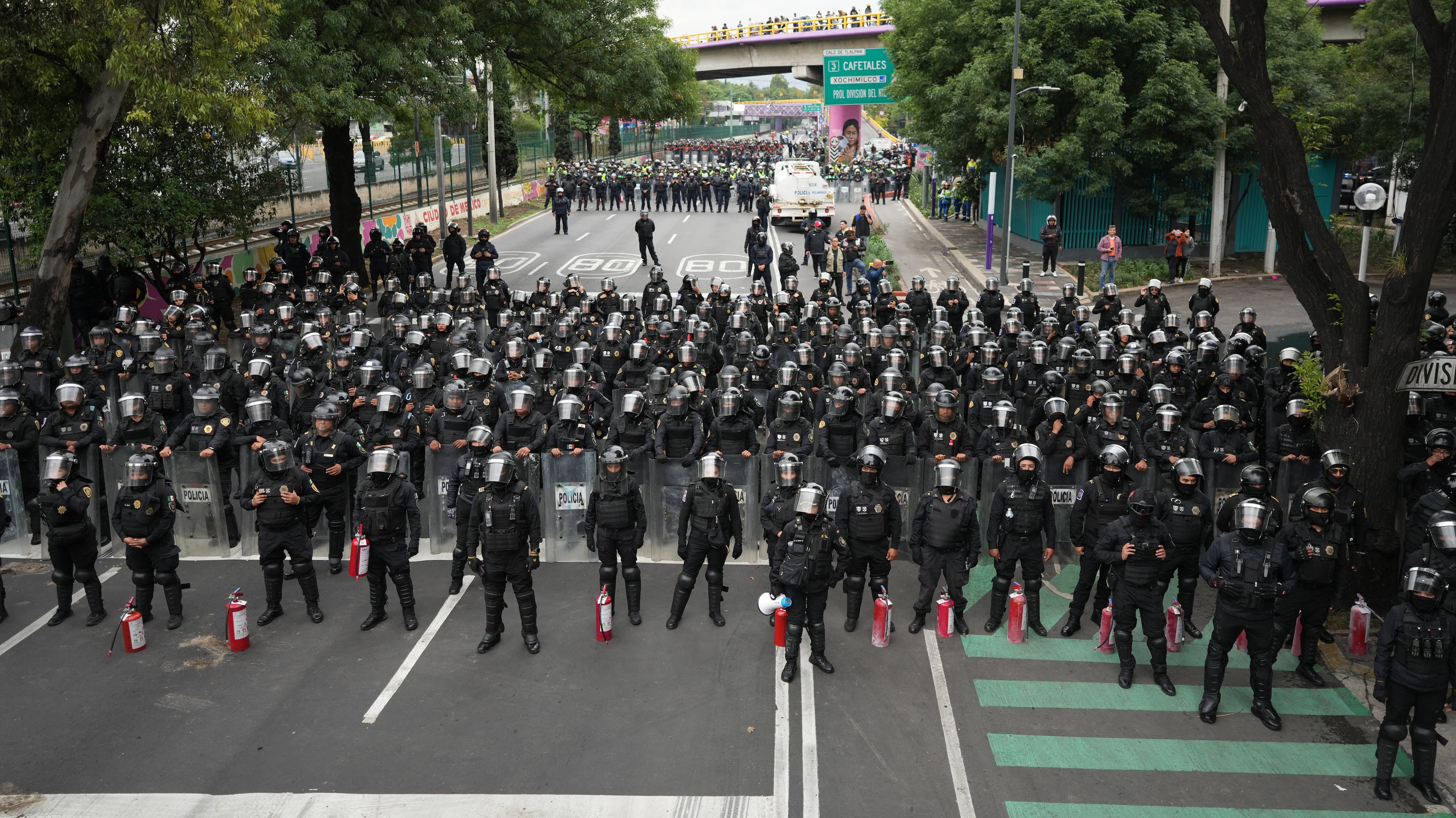 Police block an avenue to prevent protesting teachers from marching to the stadium that will host the opening match of the FIFA World Cup in Mexico City, Tuesday, June 9, 2026. (AP Photo/Eduardo Verdugo)