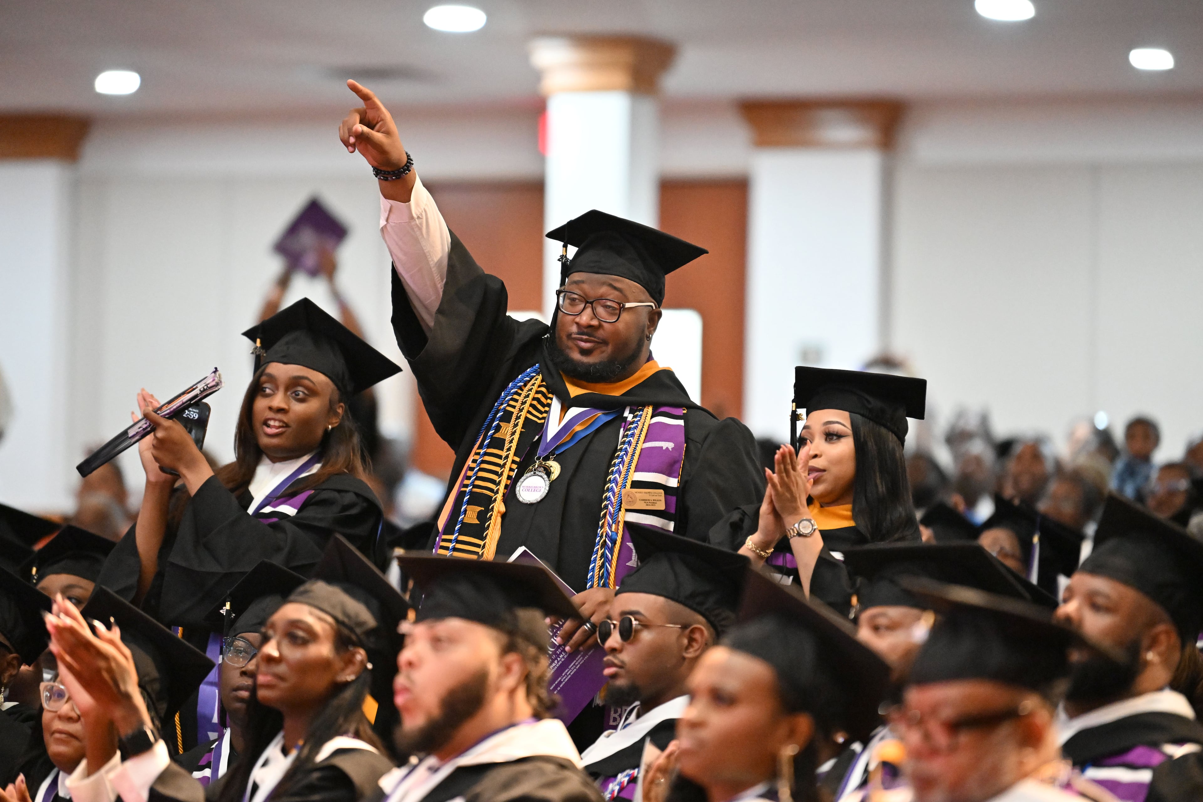 Graduates react during 2025 Morris Brown College commencement exercises at Saint Philip A.M.E. Church, Saturday, May 17, 2025, in Atlanta. (Hyosub Shin / AJC)