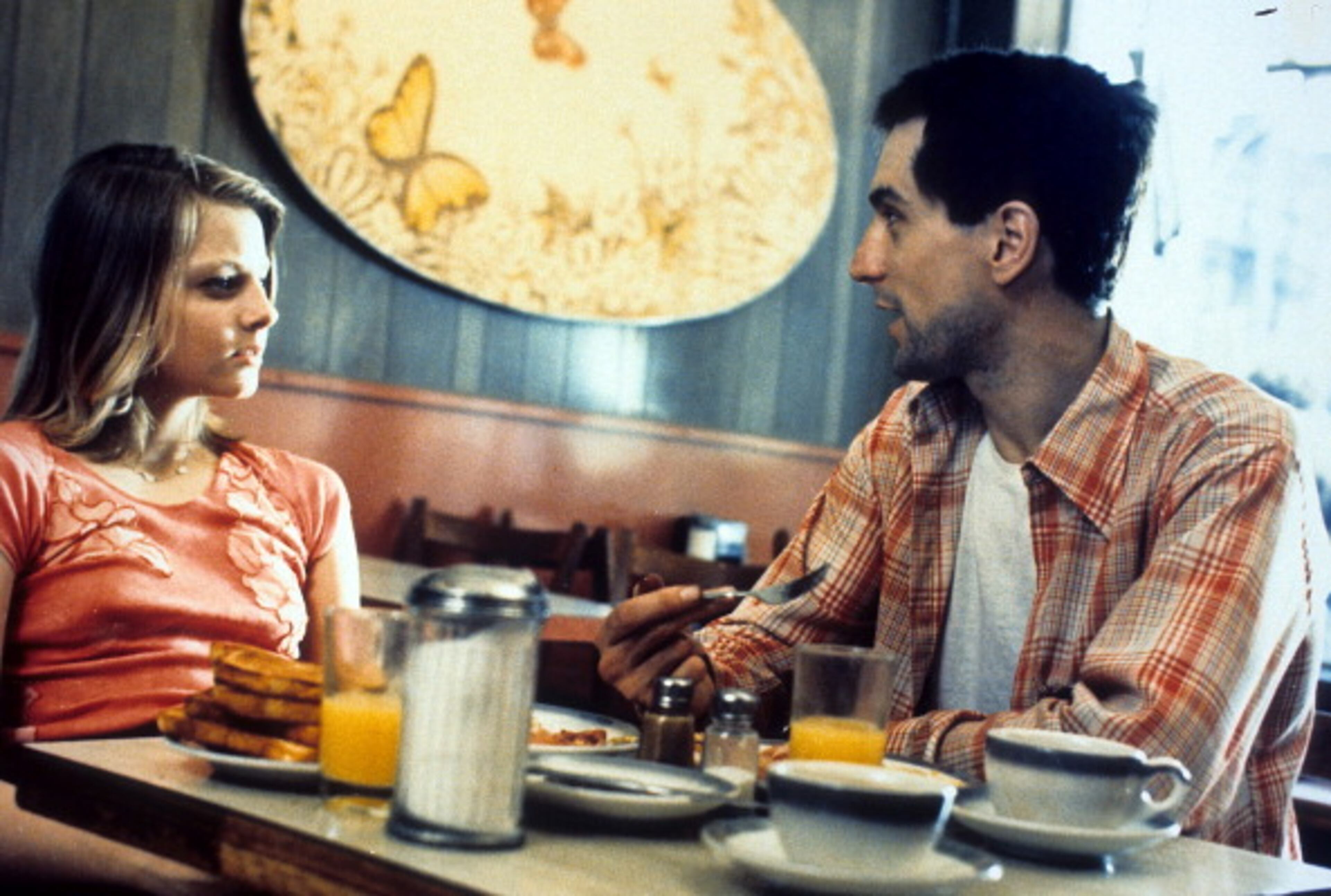 Jodie Foster and Robert De Niro at diner table in a scene from the film 'Taxi Driver', 1976. (Photo by Columbia Pictures/Getty Images)