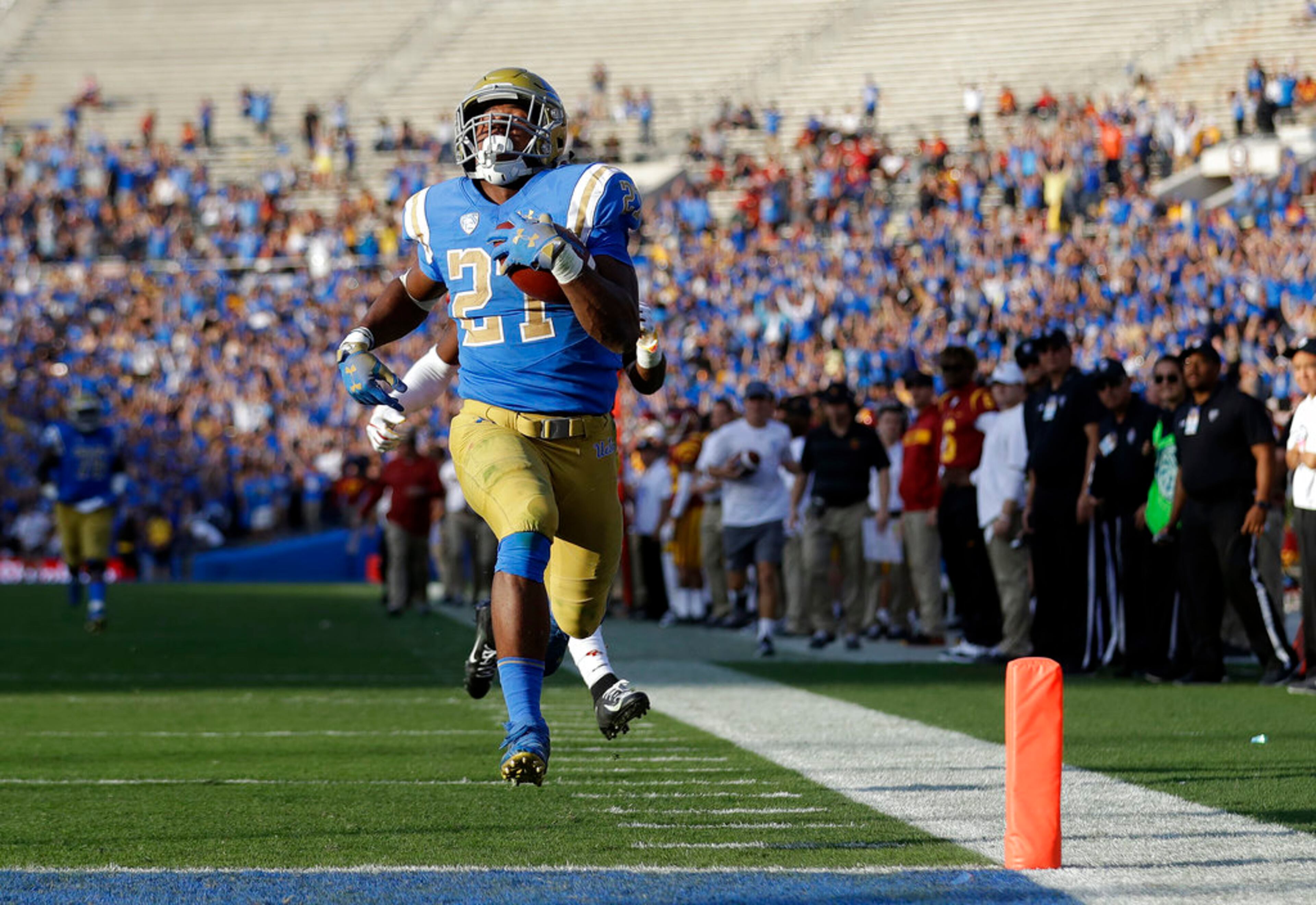 UCLA running back Joshua Kelley (27) scores a rushing touchdown against Southern California during the second half of an NCAA college football game Saturday, Nov. 17, 2018, in Pasadena, Calif. (AP Photo/Marcio Jose Sanchez)