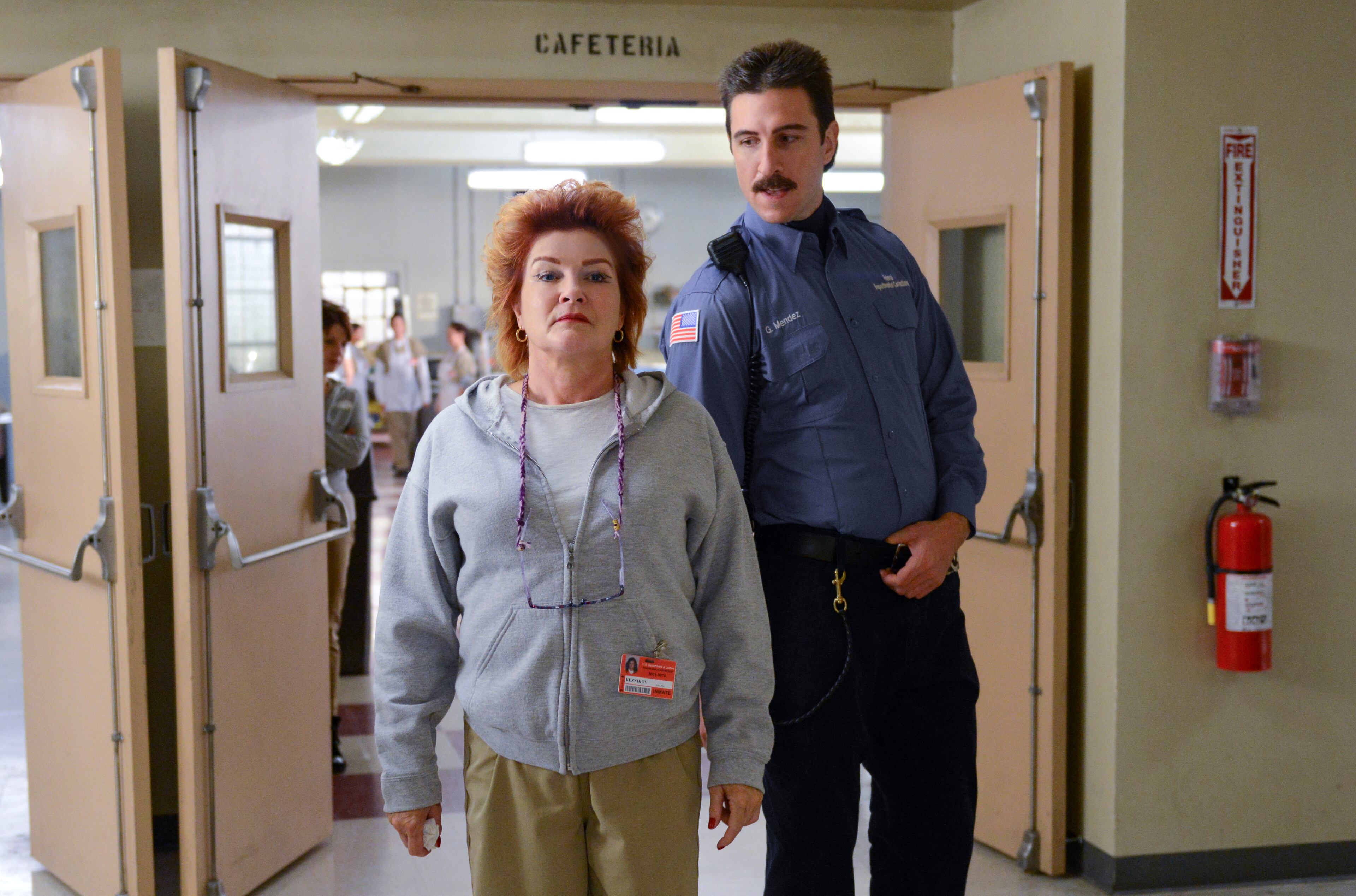 This image released by Netflix shows Kate Mulgrew, left, and Pablo Schreiber in a scene from "Orange is the New Black." The second season of the prison series will be available on Friday, June 6, on Netflix. (AP Photo/Netflix, Ali Goldstein)