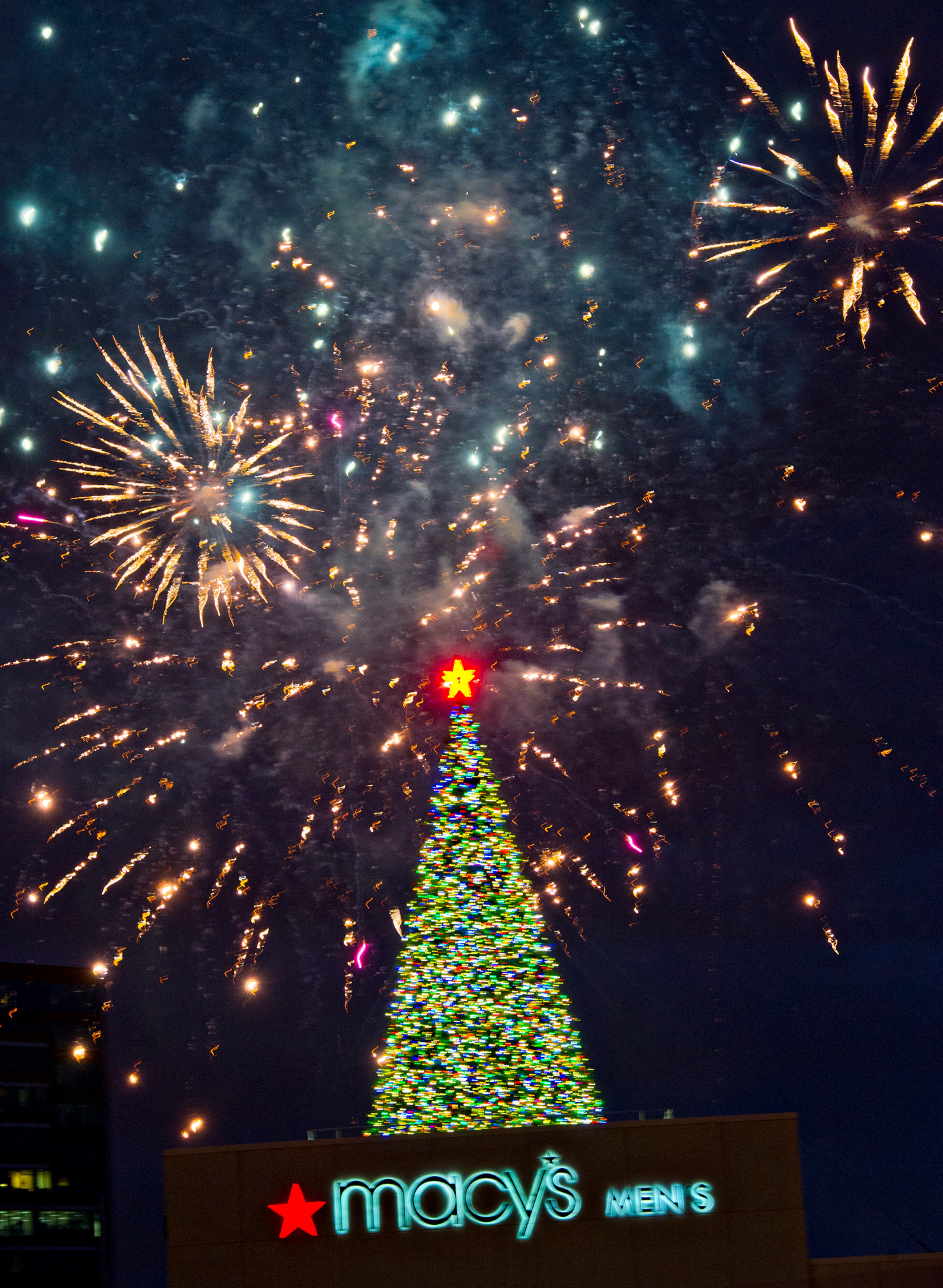 Fireworks go off above the Christmas tree on top of the Macy's building at Lenox Square Mall in Atlanta during the annual tree lighting ceremony on Thursday, Nov. 27, 2014. Thousands of people came out to watch the show which featured performances by The Isley Brothers, Pentatonix, tenor Timothy Miller and many more. JONATHAN PHILLIPS / SPECIAL