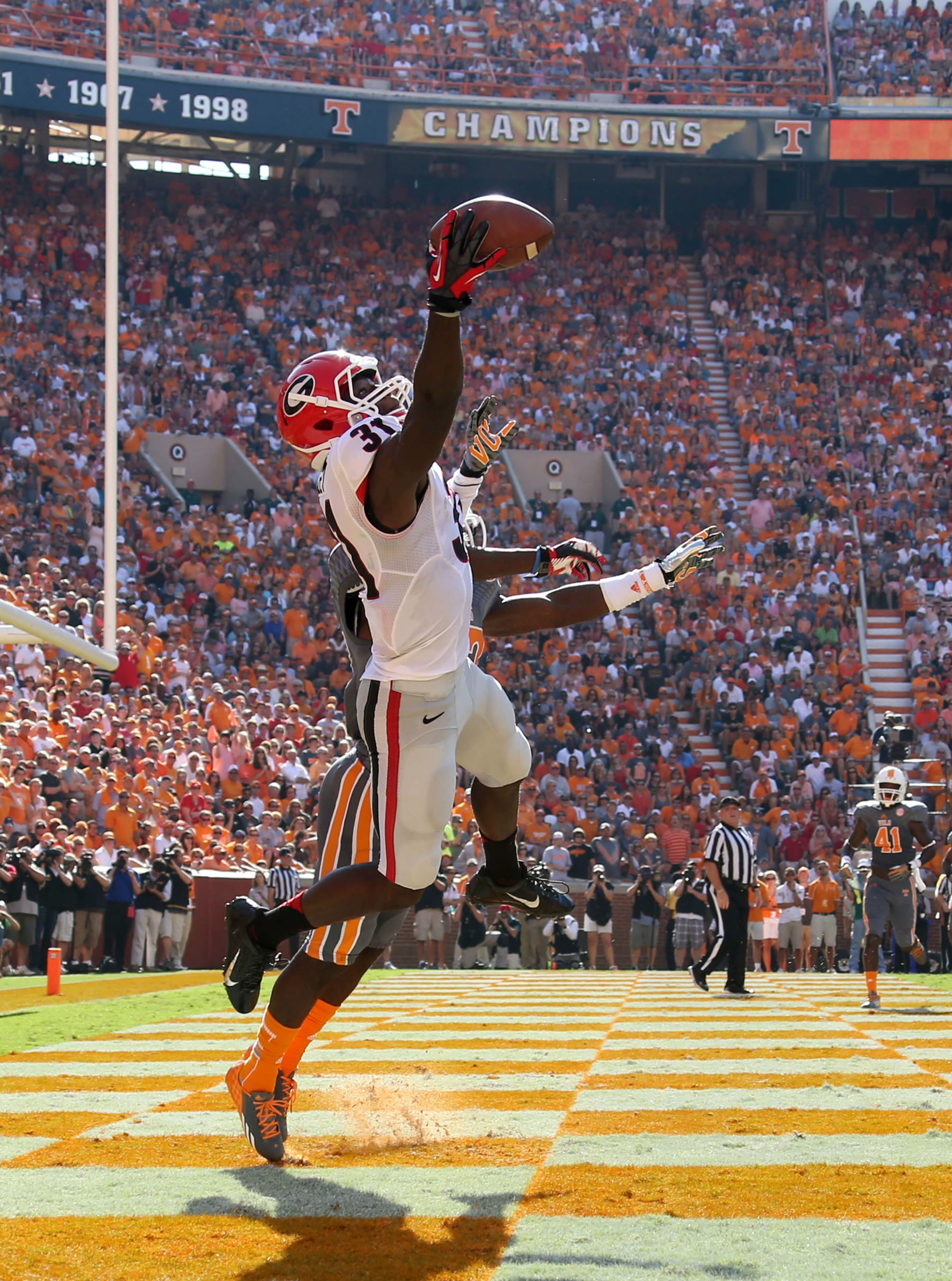 Georgia Bulldogs wide receiver Chris Conley (31) makes a one handed 1-yard touchdown pass in front of Tennessee Volunteers defensive back Justin Coleman (27) in the first half of their game at Neyland Stadium Saturday afternoon in Knoxville, Tn., October 5, 2013.