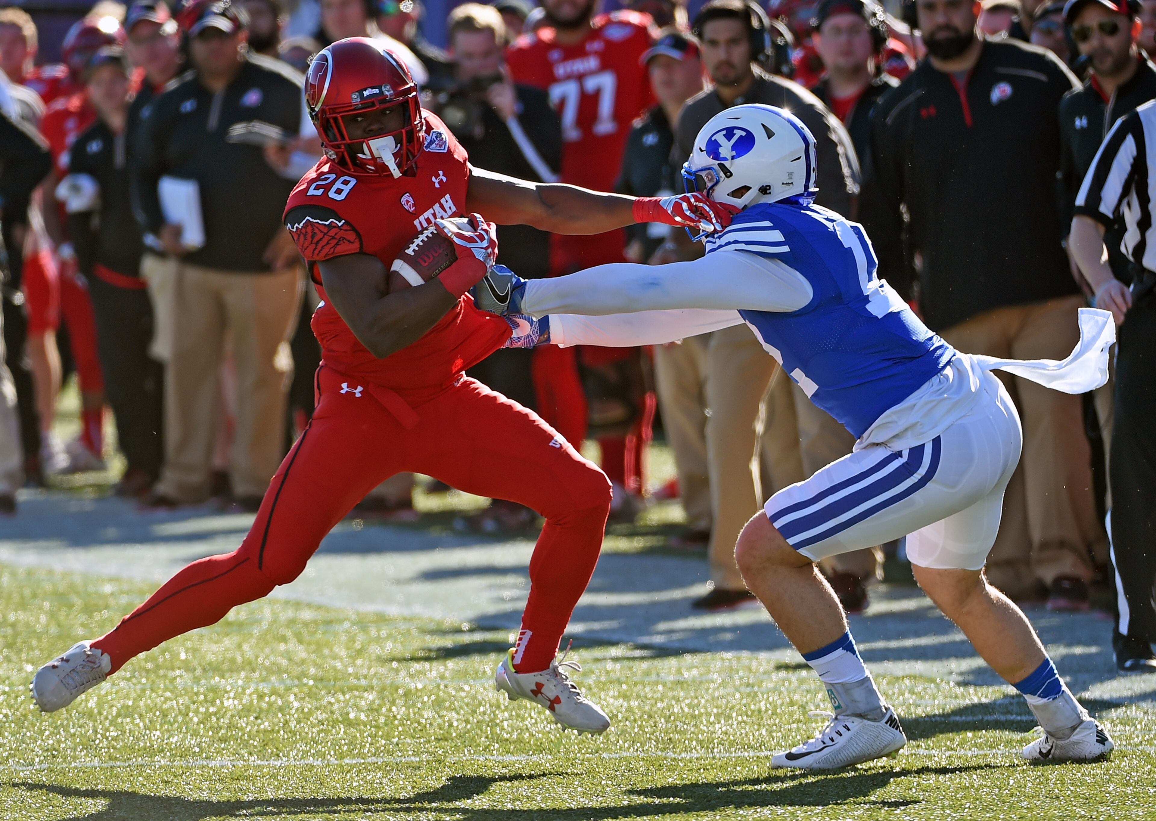 LAS VEGAS, NV - DECEMBER 19: Running back Joe Williams #28 of the Utah Utes runs for yardage against defensive back Kai Nacua #12 of the Brigham Young Cougars during the Royal Purple Las Vegas Bowl at Sam Boyd Stadium on December 19, 2015 in Las Vegas, Nevada. (Photo by Ethan Miller/Getty Images)