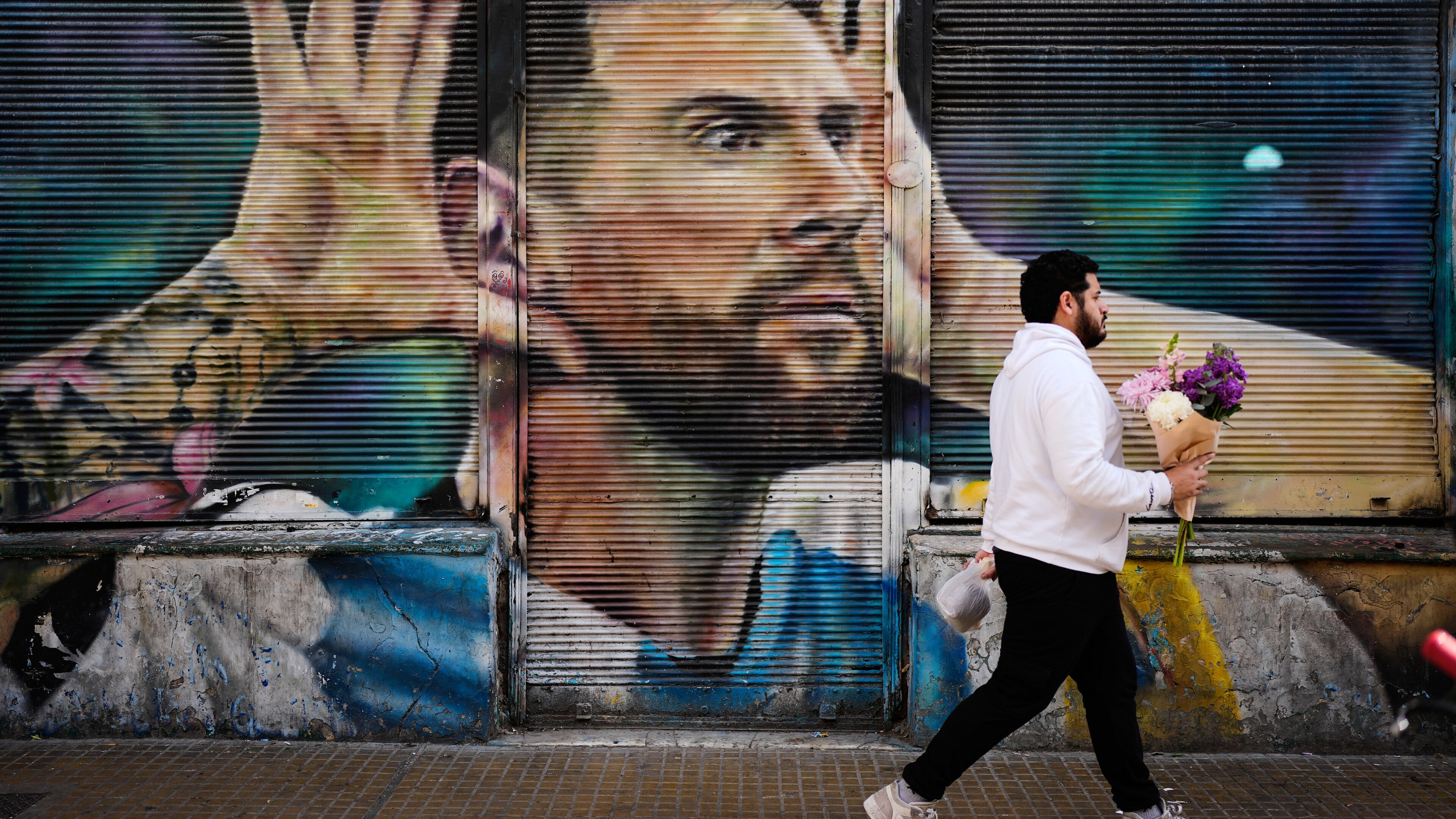 A man walks past by a mural of Argentina soccer player Lionel Messi in Buenos Aires, Argentina, Monday, Aug. 31, 2026. (AP Photo/Natacha Pisarenko)