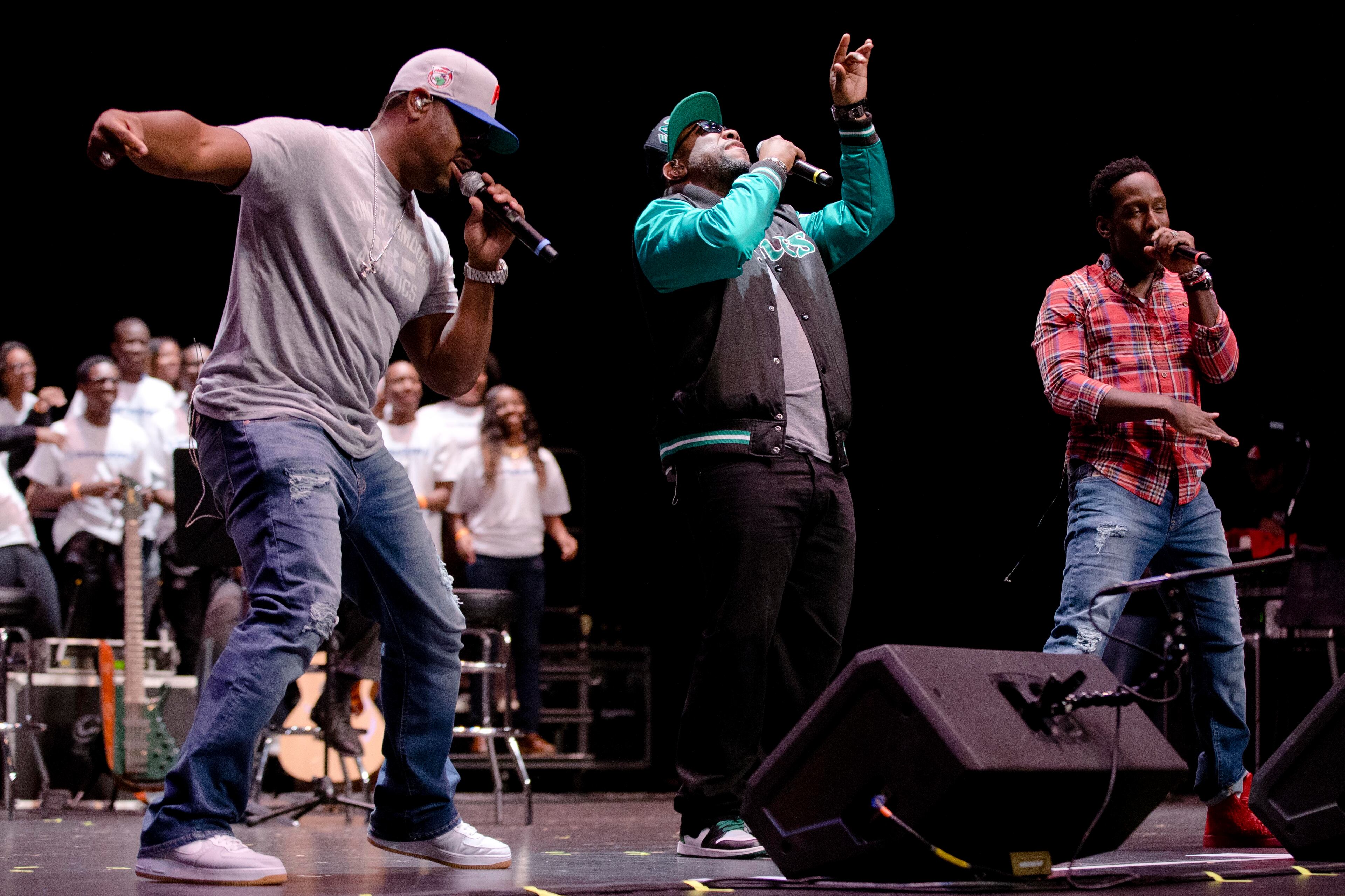 Nathan Morris, from left, Wanya Morris and Shawn Stockman of the musical group Boyz II Men, perform at their alma mater, Creative and Performing Arts High School, Tuesday, Oct. 14, 2014, in Philadelphia. The Grammy-winning R&B group, best known for '90s hits like "I'll Make Love To You" and "Motownphilly," is set to release their new album, "Collide," next week. (AP Photo/Matt Rourke)