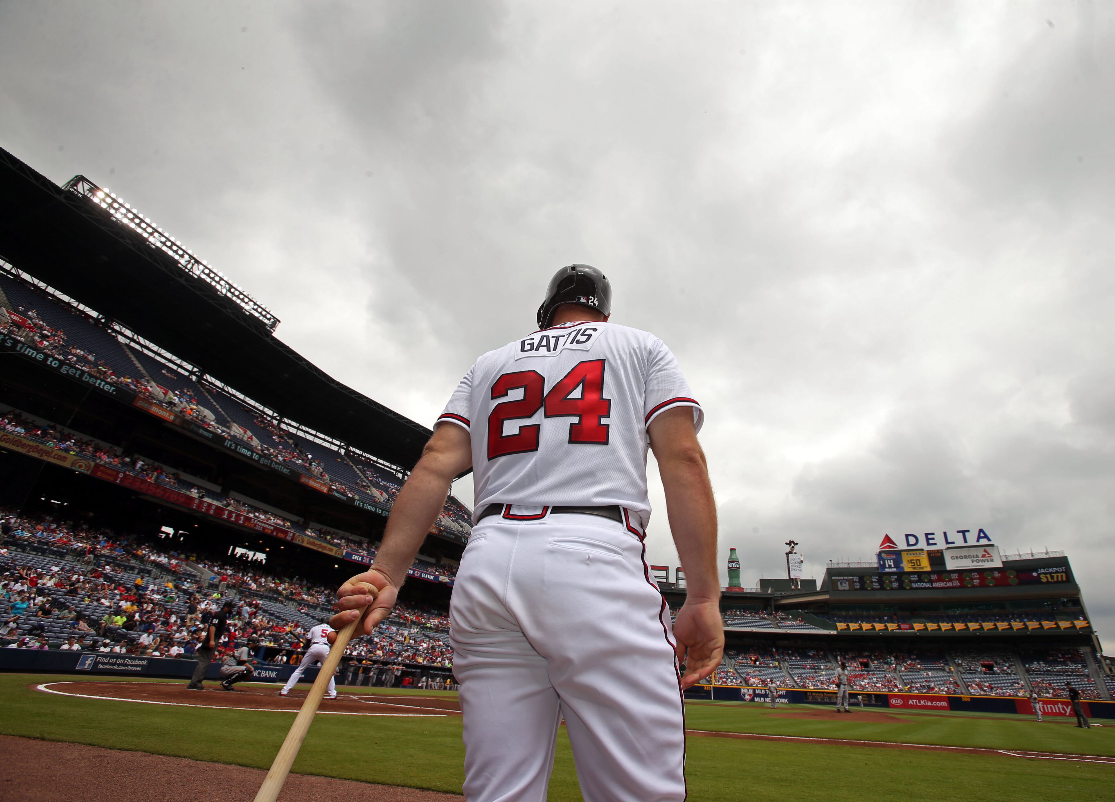 Braves left fielder Evan Gattis warms up on deck in the first inning. Gattis hit a solo home run in the sixth inning. JASON GETZ / JGETZ@AJC.COM