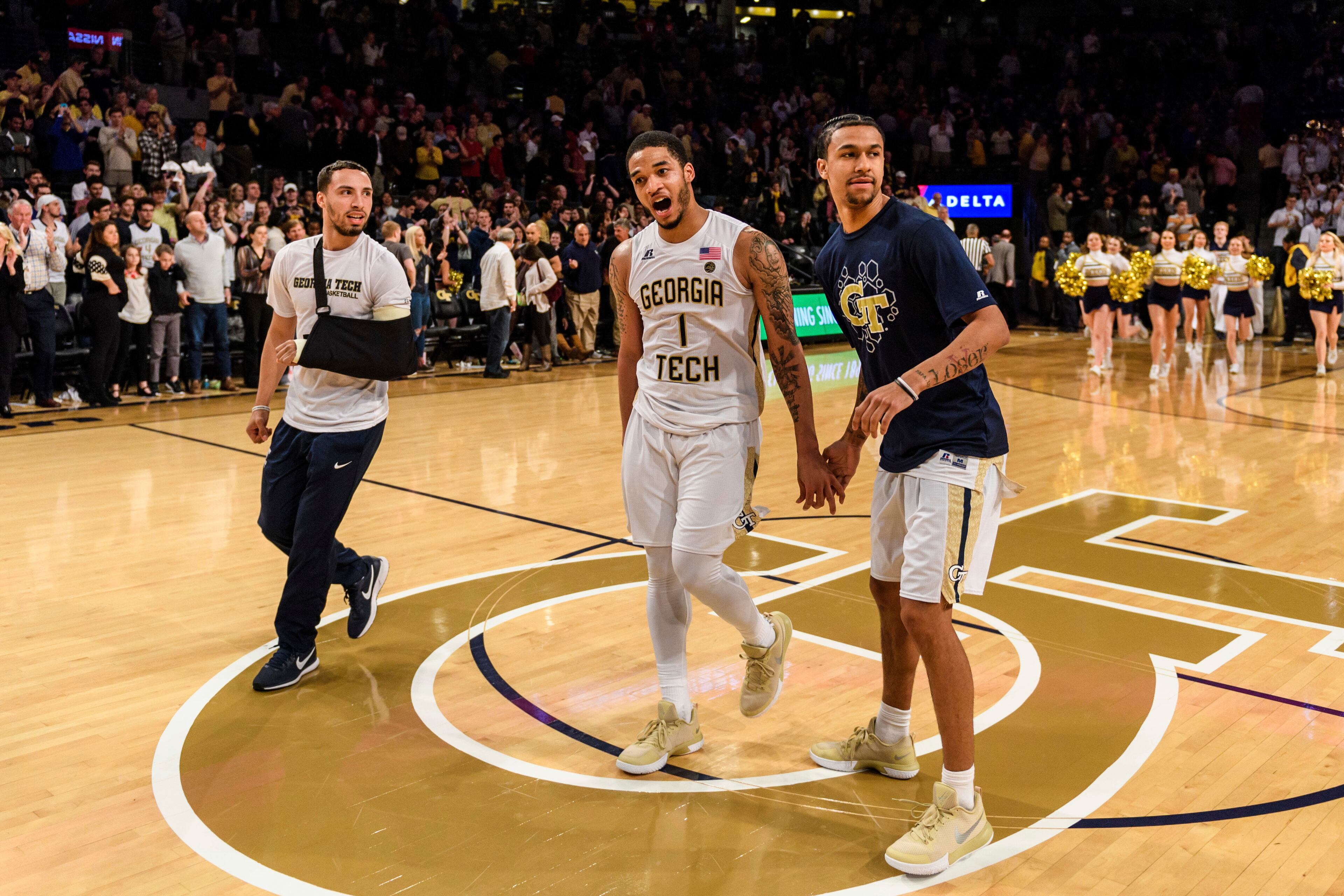 Georgia Tech guard Tadric Jackson, center, celebrates with teammates Jose Alvarado, left, and Justin Moore, right, after defeating North Carolina State in an NCAA college basketball game, in Atlanta, Thursday, March 1, 2018. (AP Photo/Danny Karnik)