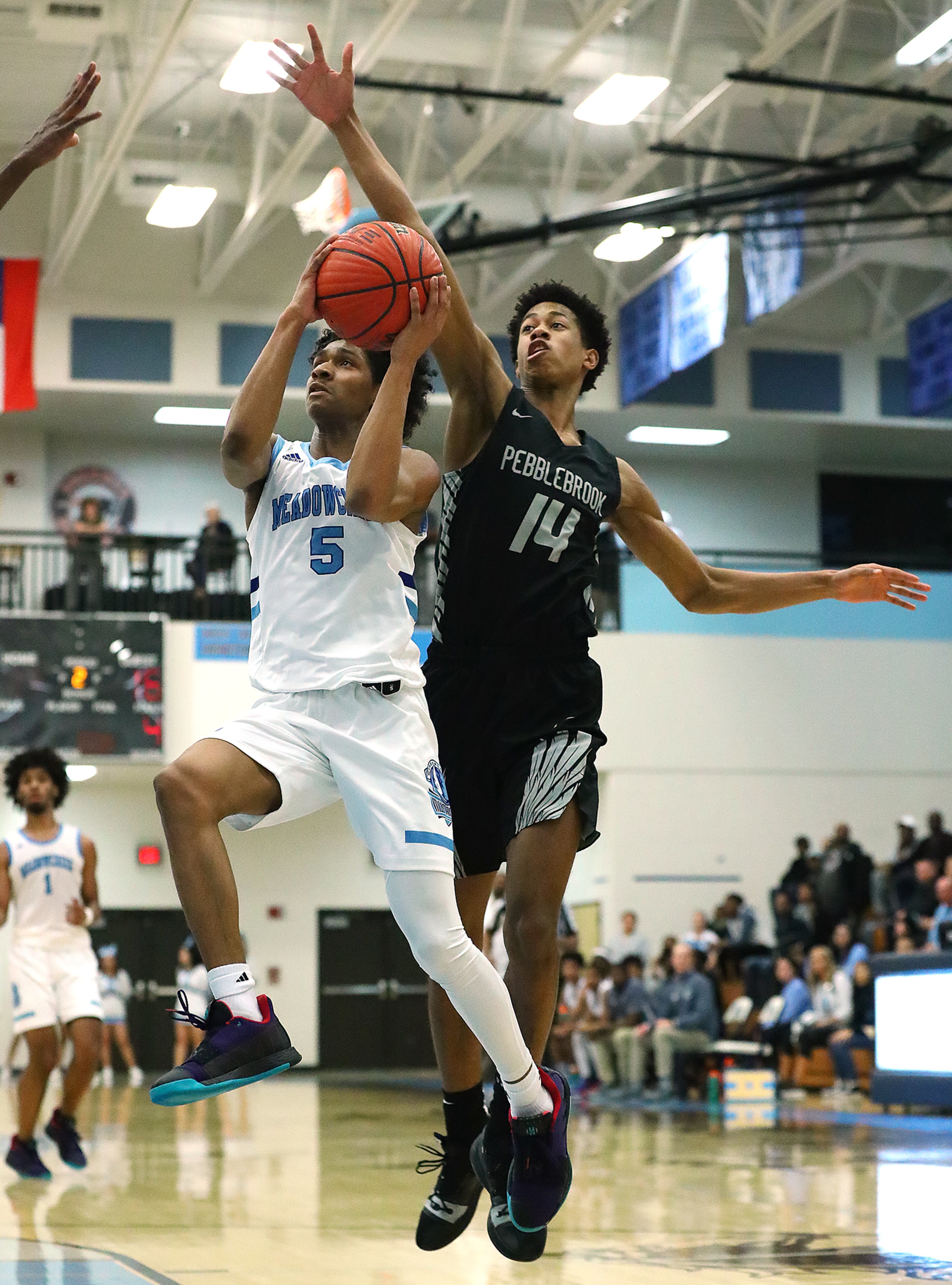Feb. 27, 2019 Norcross: Meadowcreek guard Jalen Benjamin goes to the basket for two points past Pebblebrook defender Kaleb Washington in a AAAAAAA quarterfinal high school boys basketball game at Meadowcreek High School on Wednesday, Feb. 27, 2019, in Norcross. Curtis Compton/ccompton@ajc.com