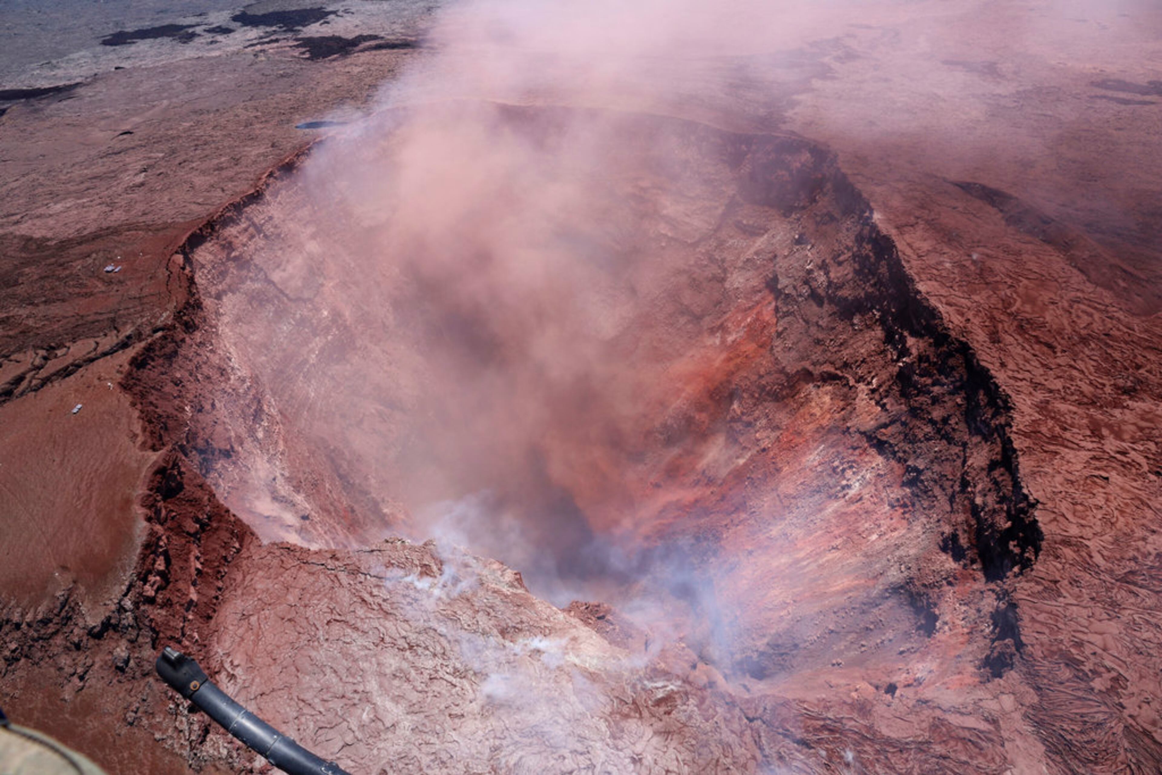 In this photo released by U.S. Geological Survey, a plume of ash rises from the Puu Oo vent on Hawaii's Kilaueaa Volcano Thursday, May 3, 2018 in Hawaii Volcanoes National Park. Hawaii's Kilauea volcano erupted Thursday, sending lava shooting into the air in a residential neighborhood and prompting mandatory evacuation orders for nearby homes. Hawaii County said steam and lava poured out of a crack in Leilani Estates, which is near the town of Pahoa on the Big Island. (U.S. Geological Survey via AP)