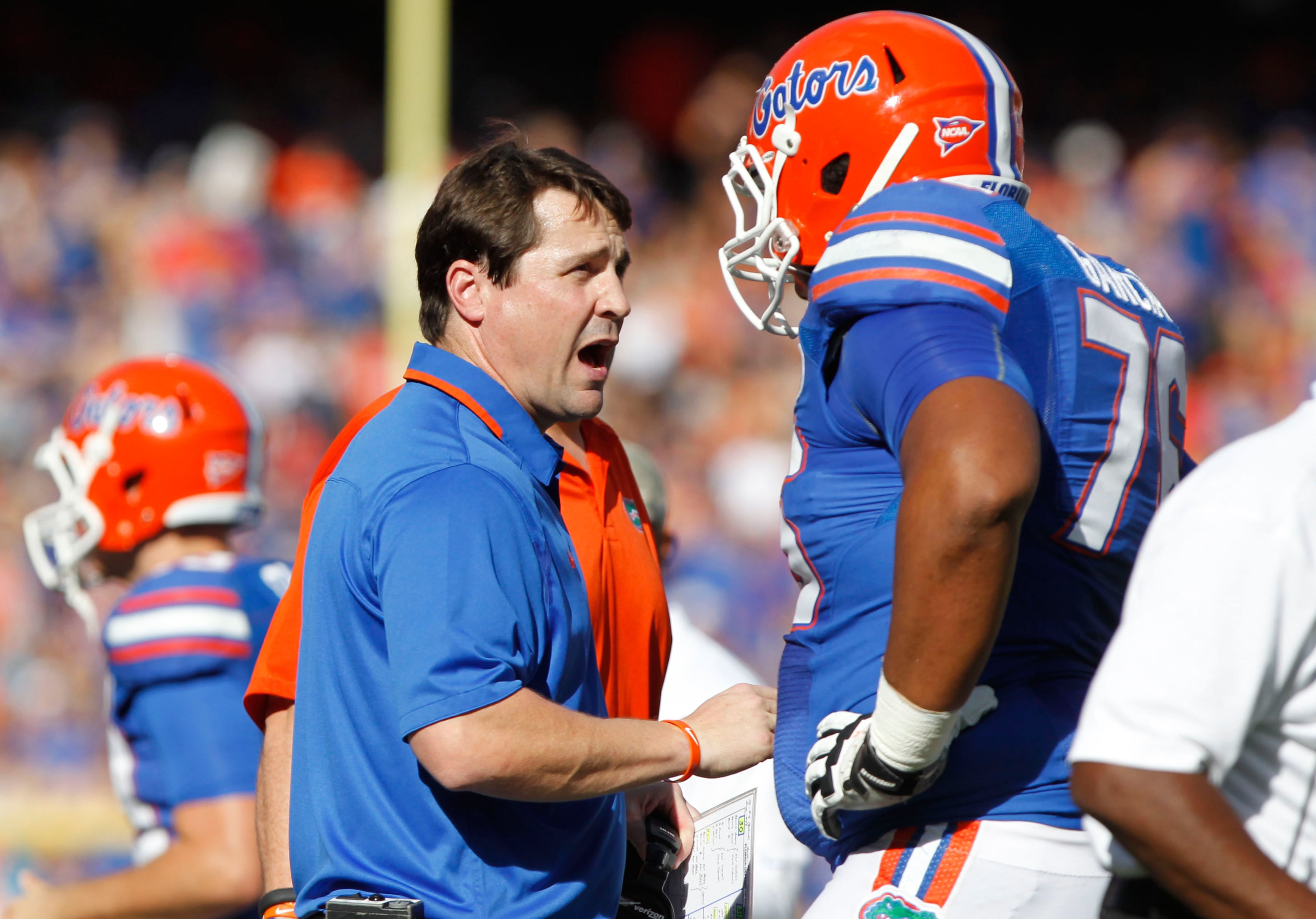 Florida Gators head coach Will Muschamp talks with linesman Max Garcia (76) against the Georgia Southern Eagles during the first quarter at Ben Hill Griffin Stadium. Mandatory Credit: Kim Klement-USA TODAY Sports