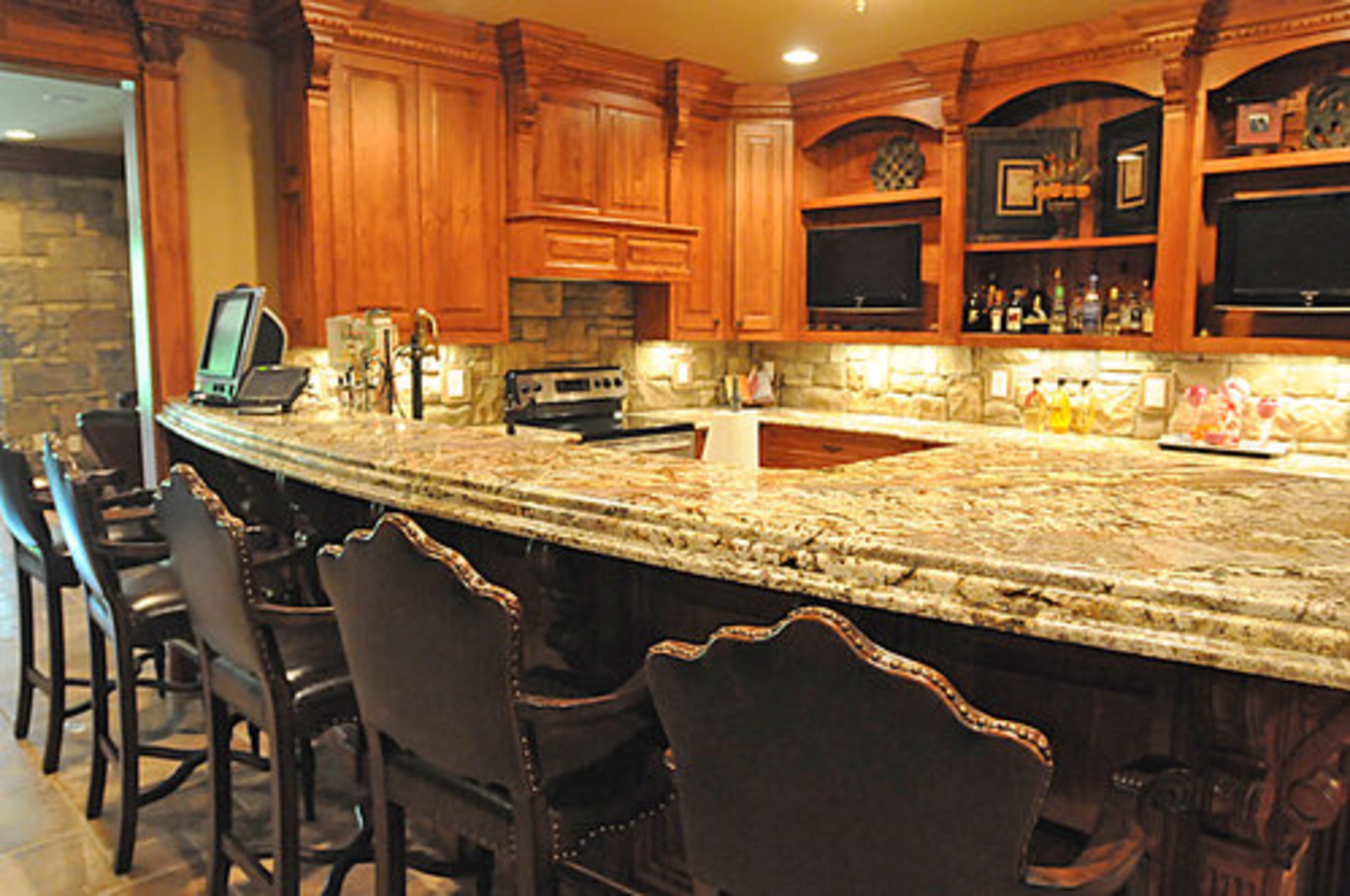 The classy bar and kitchen area is headquarters-central for a sophisticated party.