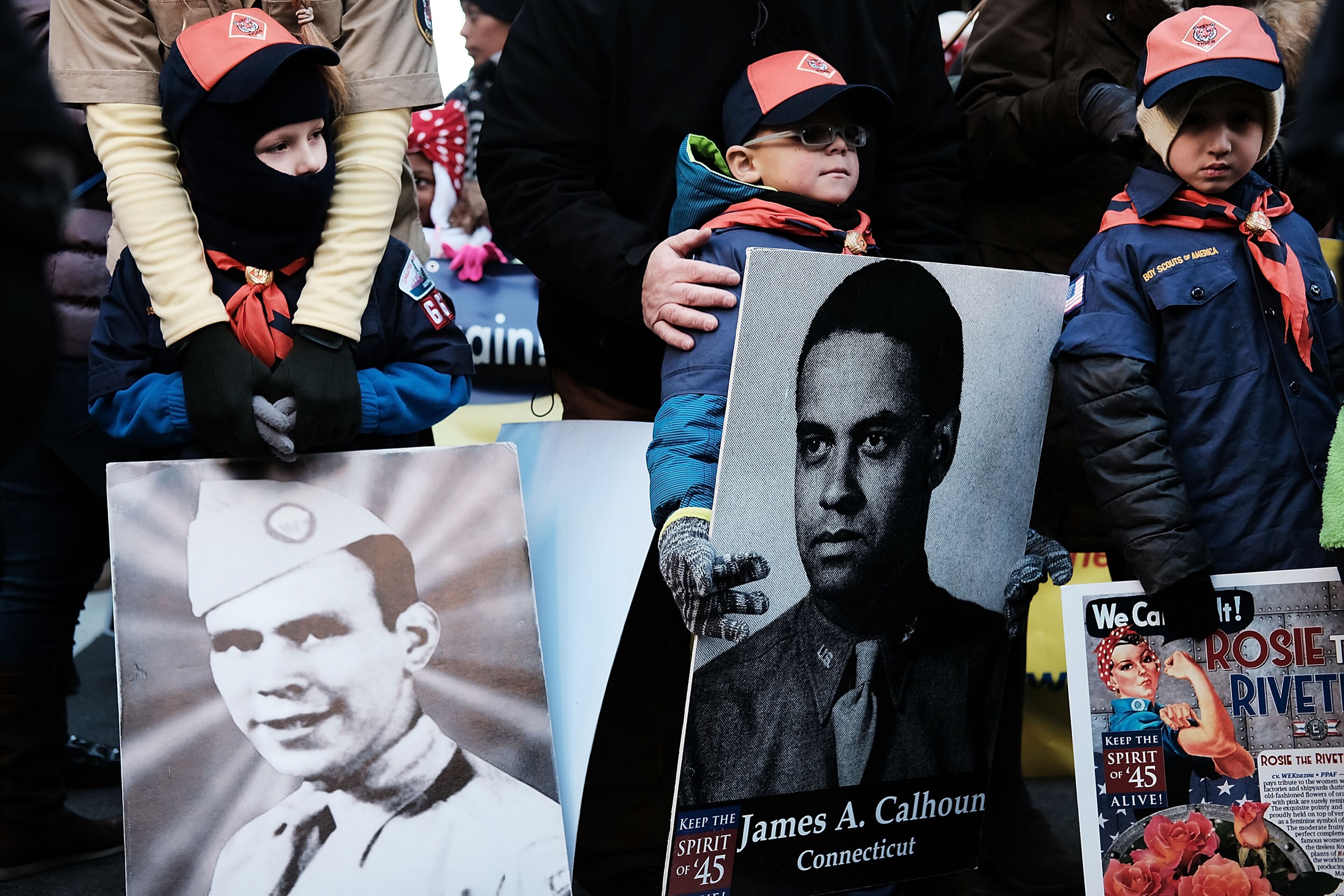 NEW YORK, NY - NOVEMBER 11: Boy Scouts holding historic pictures of fallen soilders from the World War II prepare to march in the Veterans Day Parade on November 11, 2017 in New York City. The largest Veterans Day event in the nation, this year's parade features thousands of marchers, including military units, civic and youth groups, businesses and high school bands from across the country and veterans of all eras. The U.S. Air Force is this year's featured service and the grand marshal is space pioneer Buzz Aldrin. (Photo by Spencer Platt/Getty Images)