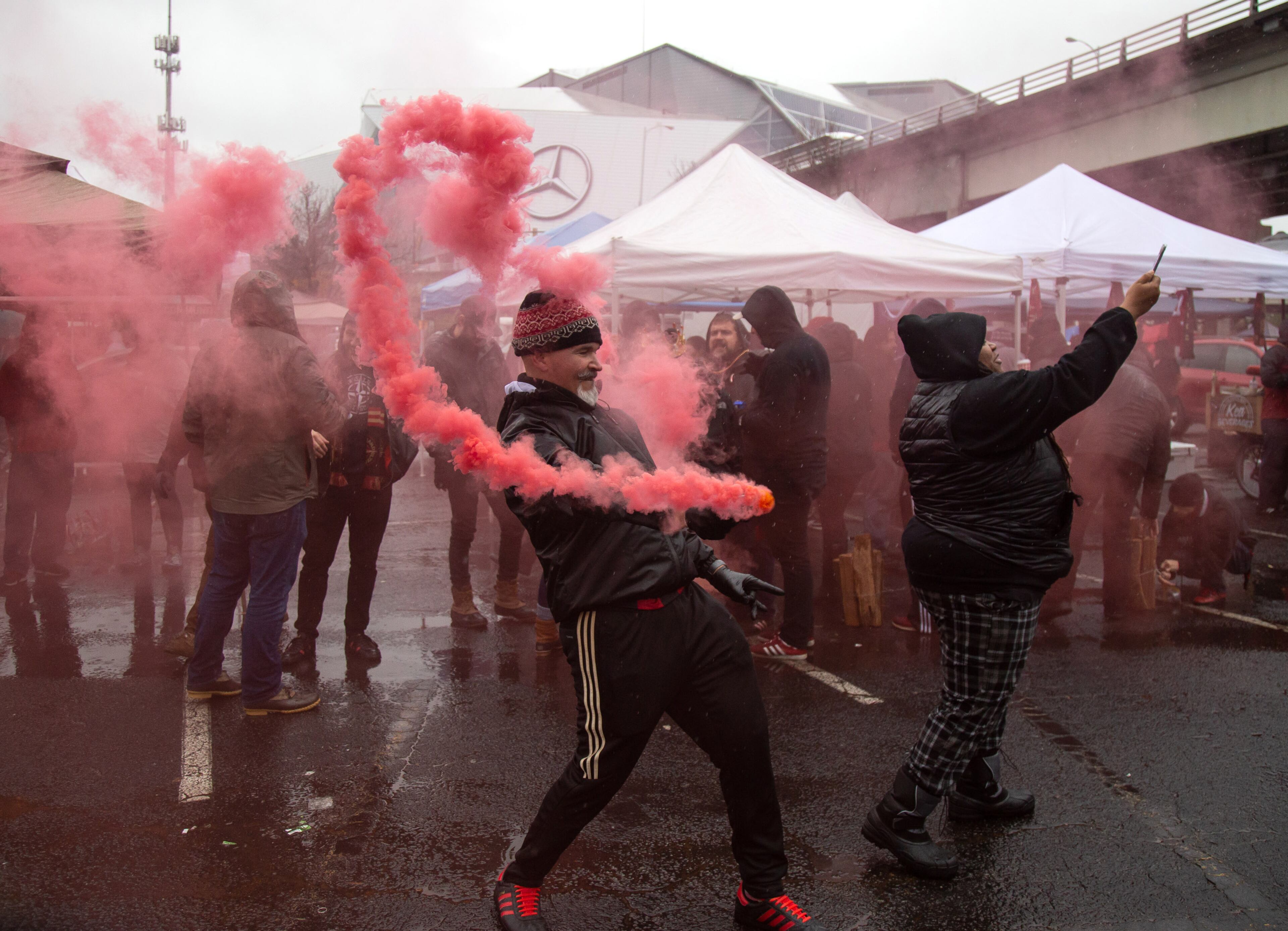Roman Sosa waves a red flair around in the Gultch before the start of the MLS championship game between the Portland Timbers and the Atlanta United FC Saturday, November 8, 2018, in Atlanta GA. STEVE SCHAEFER / SPECIAL TO THE AJC