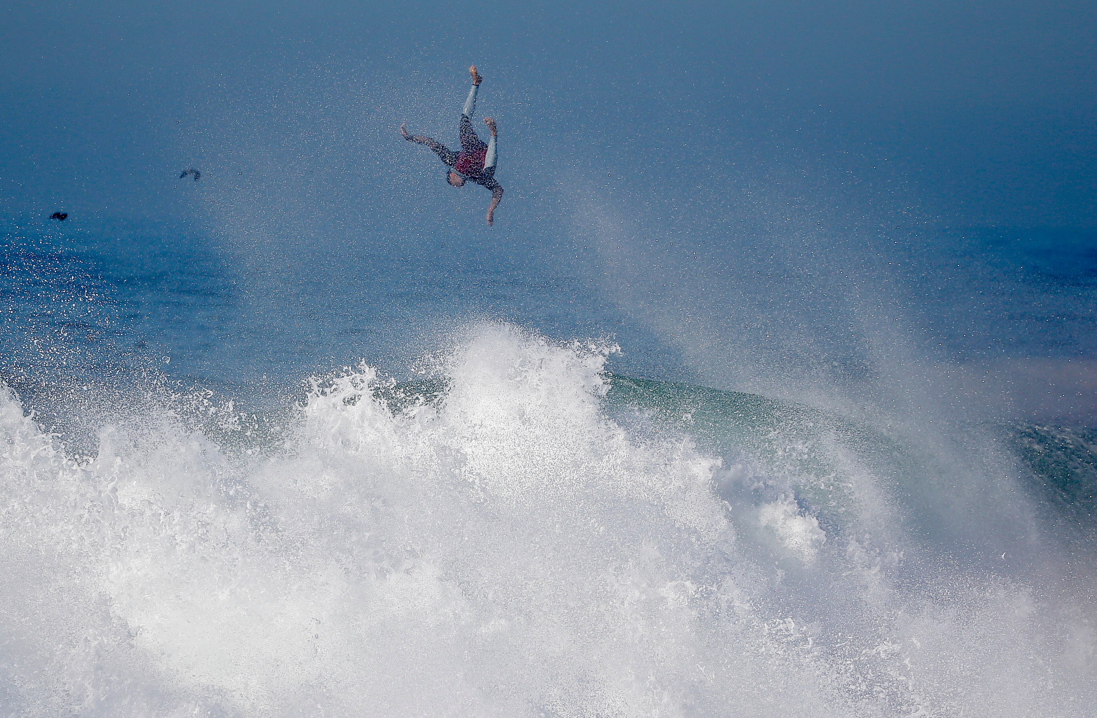 A surfer flies off a wave at the wedge in Newport Beach, Calif., Wednesday, Aug. 27, 2014. Southern California beachgoers experienced much higher than normal surf, brought on by Hurricane Marie spinning off the coast of Mexico. (AP Photo/Chris Carlson)