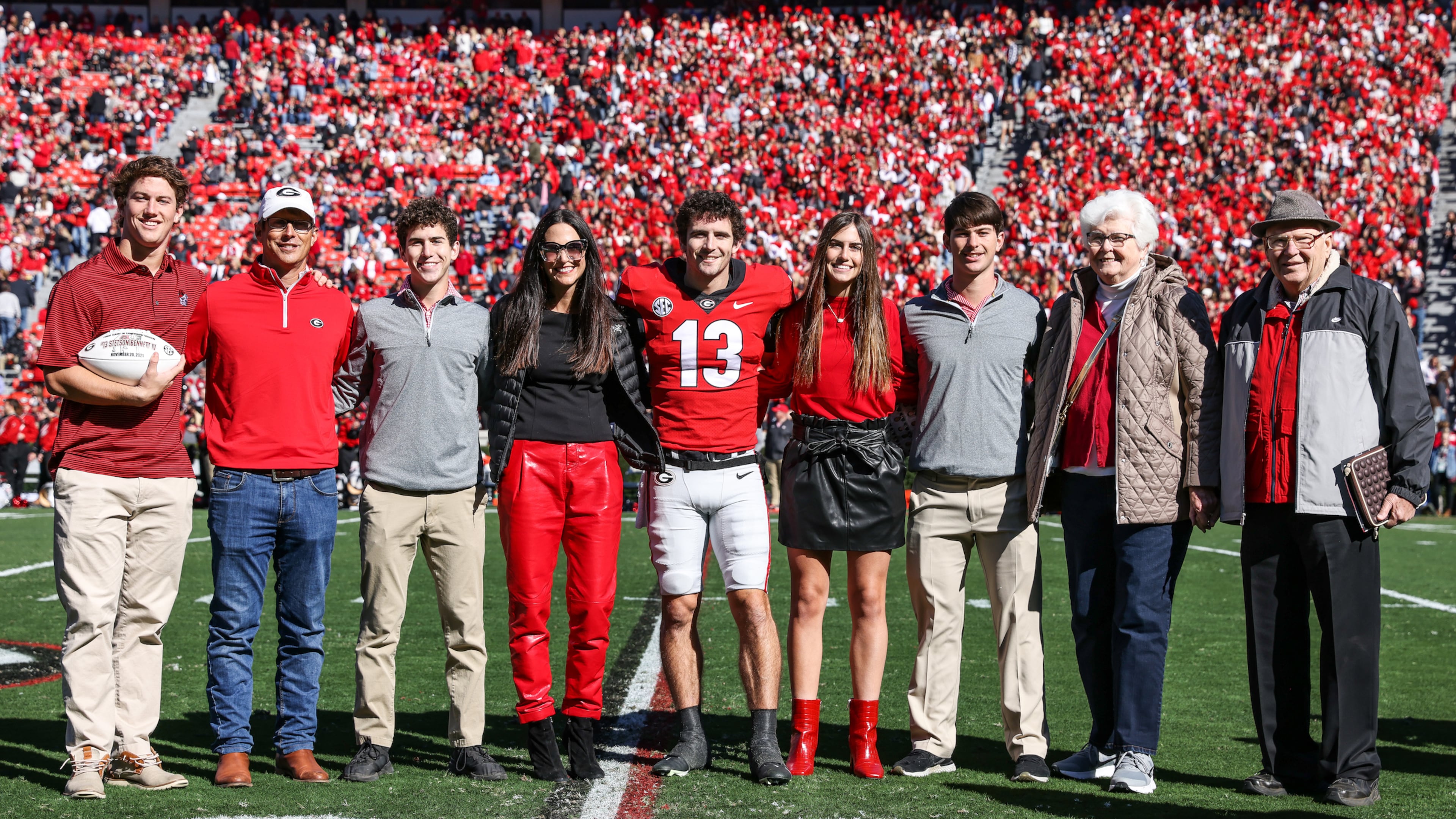 Georgia quarterback Stetson Bennett (13) poses with his family during the Senior Day ceremony before the Bulldogs’ game against Charleston Southern on Dooley Field at Sanford Stadium in Athens on Saturday, Nov. 20, 2021. His younger brother Luke, third from right, will walkon with the Bulldogs this season. (Photo by Tony Walsh/UGAAA)