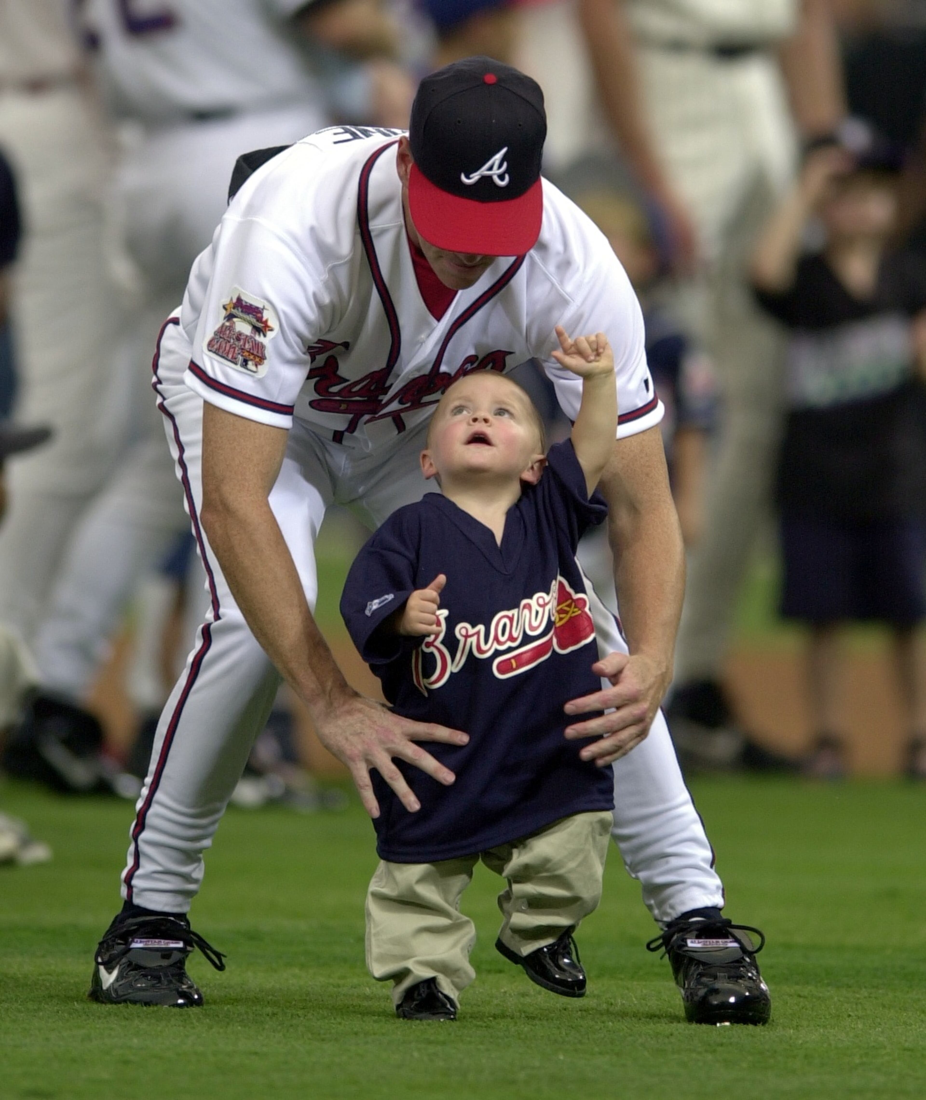Braves starting pitcher Tom Glavine with son Peyton Thomas before the start of the All-Star Game at Turner Field in 2000.