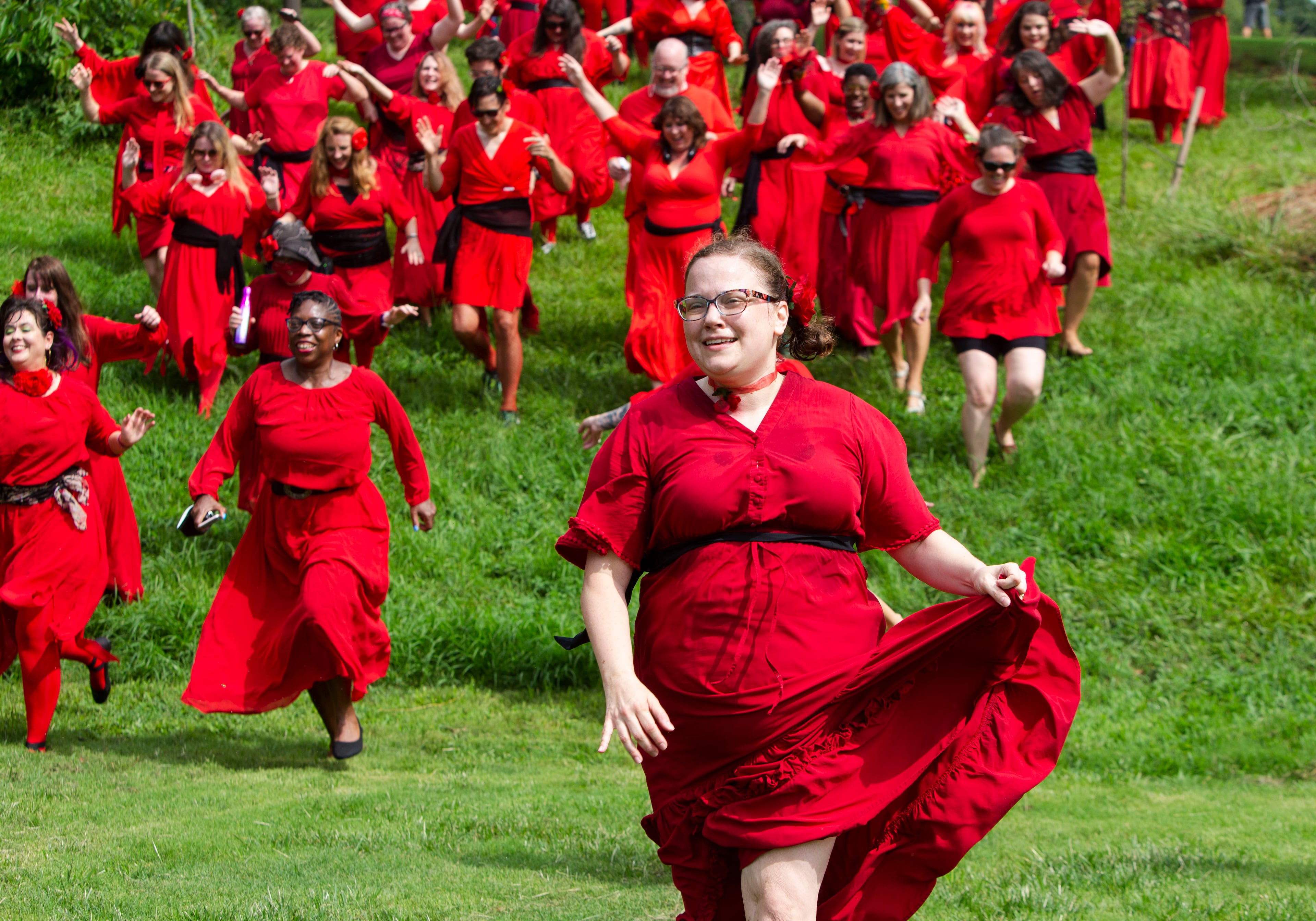 Jennie Law leads the pack of Kate Bush fans running down the hill after a group dance performance to celebrate the seventh annual international "Most Wuthering Heights Day Ever," on Saturday, July 30, 2022, in Candler Park in Atlanta. The event celebrates Kate Bush's 1978 song "Wuthering Heights" with events in more than 40 cities around the world. CHRISTINA MATACOTTA FOR THE ATLANTA JOURNAL-CONSTITUTION