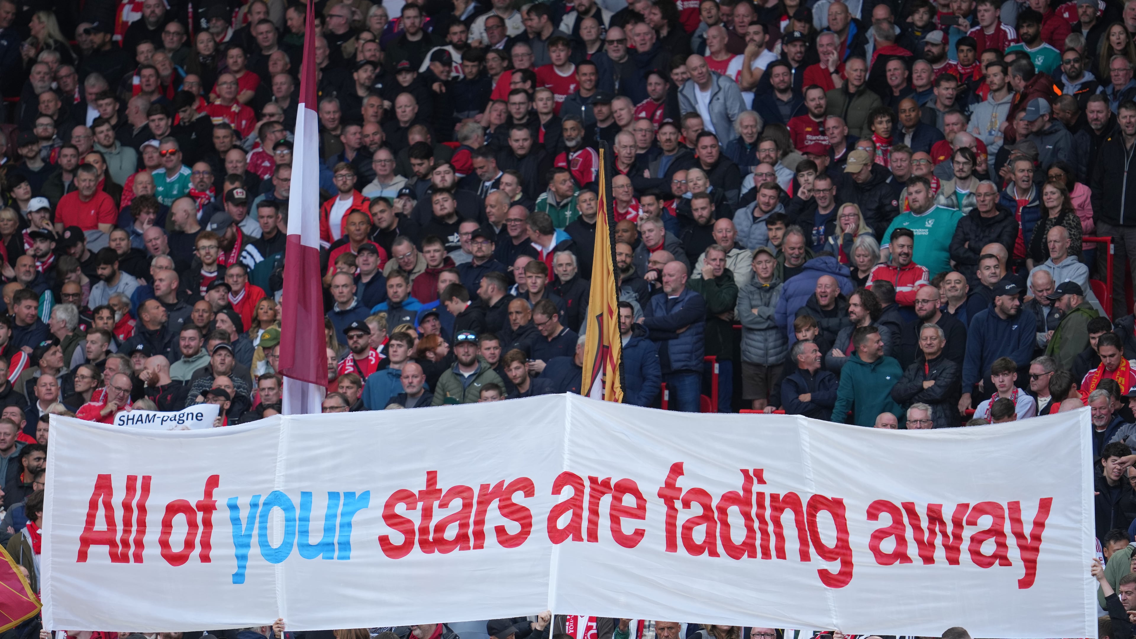 Fans display a banner as they cheer at the stand prior the English Premier League soccer match between Liverpool and Manchester City in Liverpool, England, Sunday, Oct. 11, 2026. (AP Photo/Jon Super)