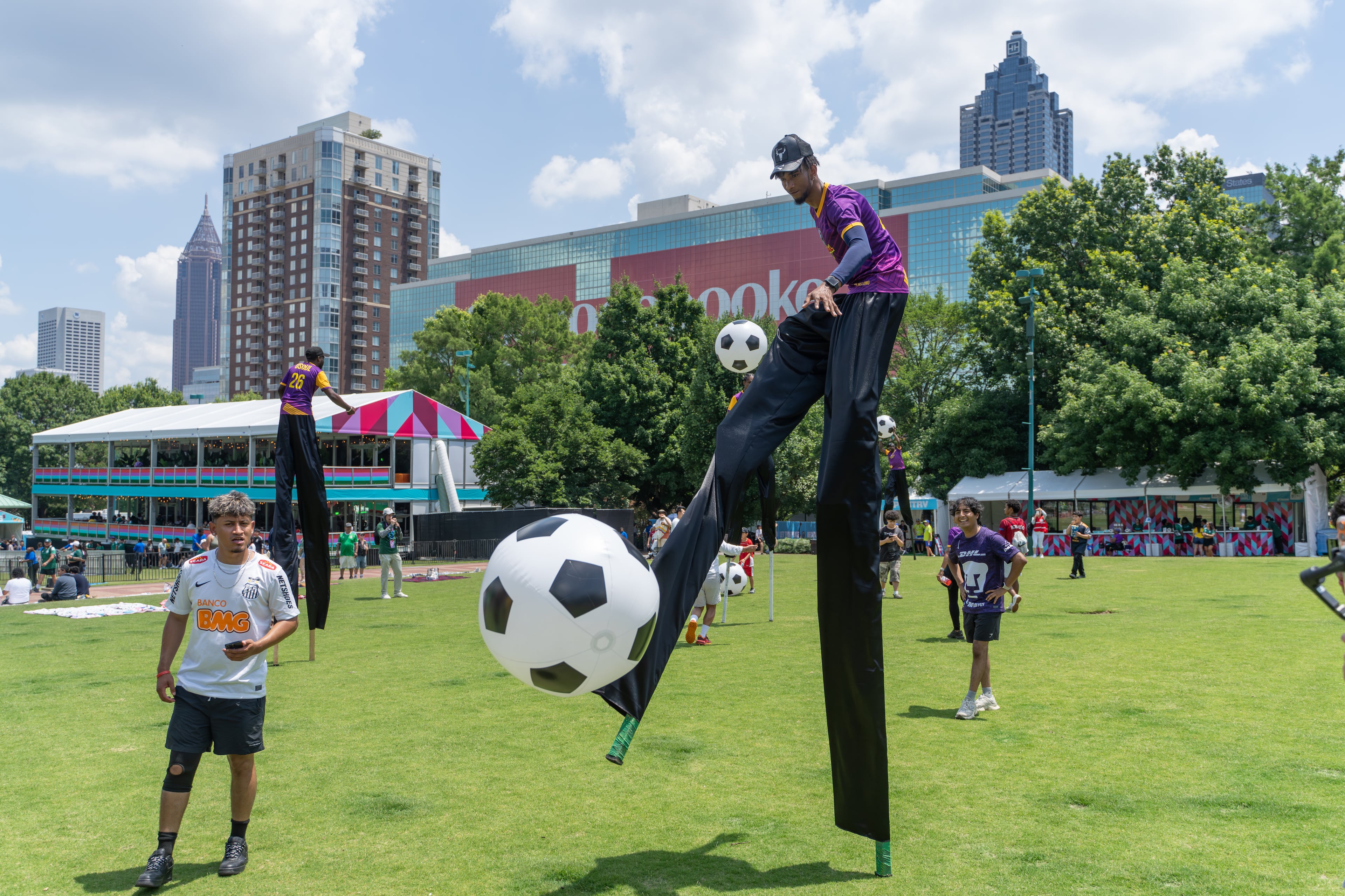 Universoul Circus performers interact with attendees during opening day of the FIFA Fan Festival at Centennial Olympic Park on Thursday, June 11, 2026. (Ben Hendren for the AJC)
