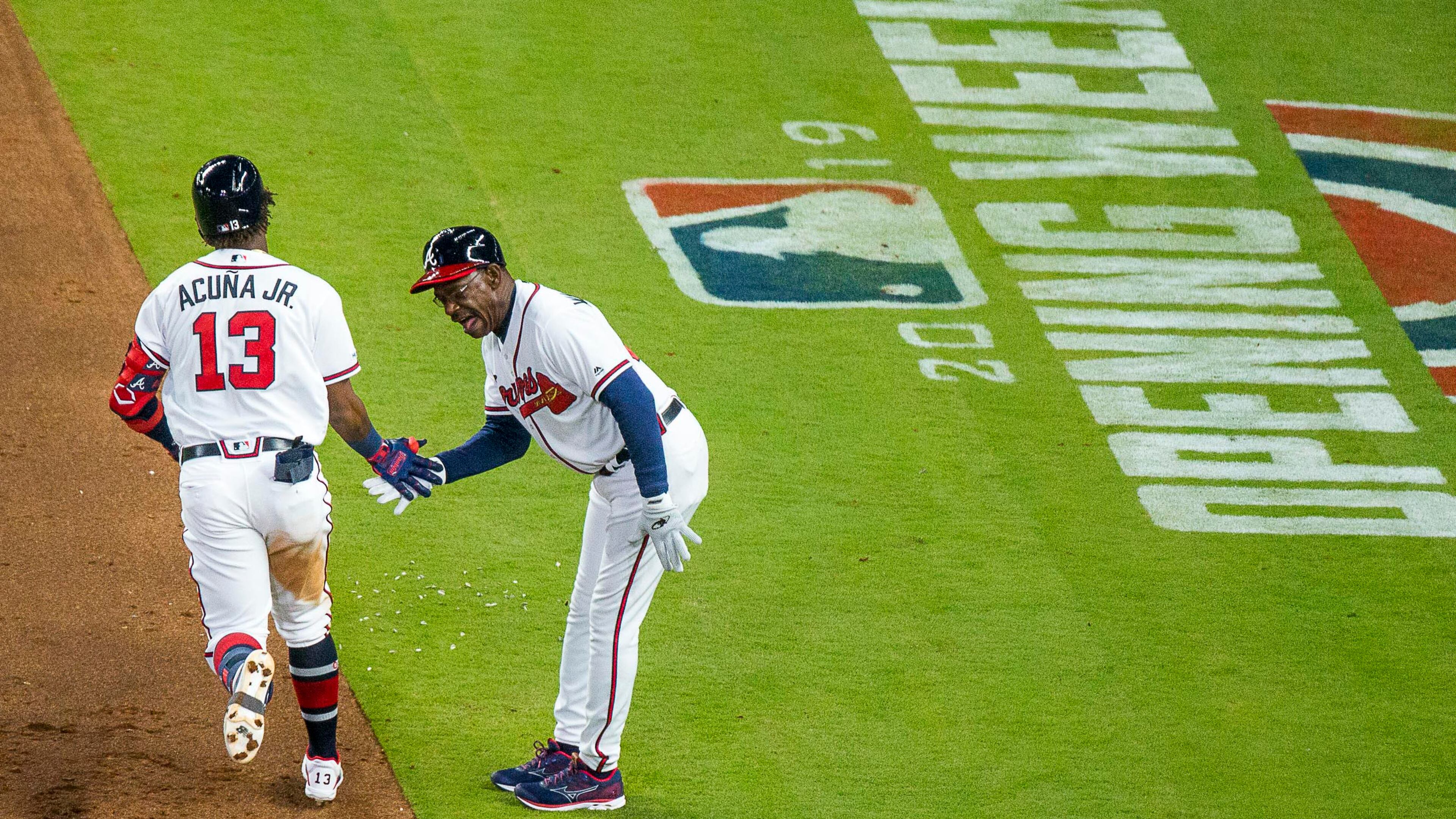 Braves third base coach Ron Washington salutes Ronald Acuna on his way home after hitting a solo home run in the third inning of the home opener Monday, April 1,
2019, against the Chicago Cubs at SuntTrust Park in Atlanta.