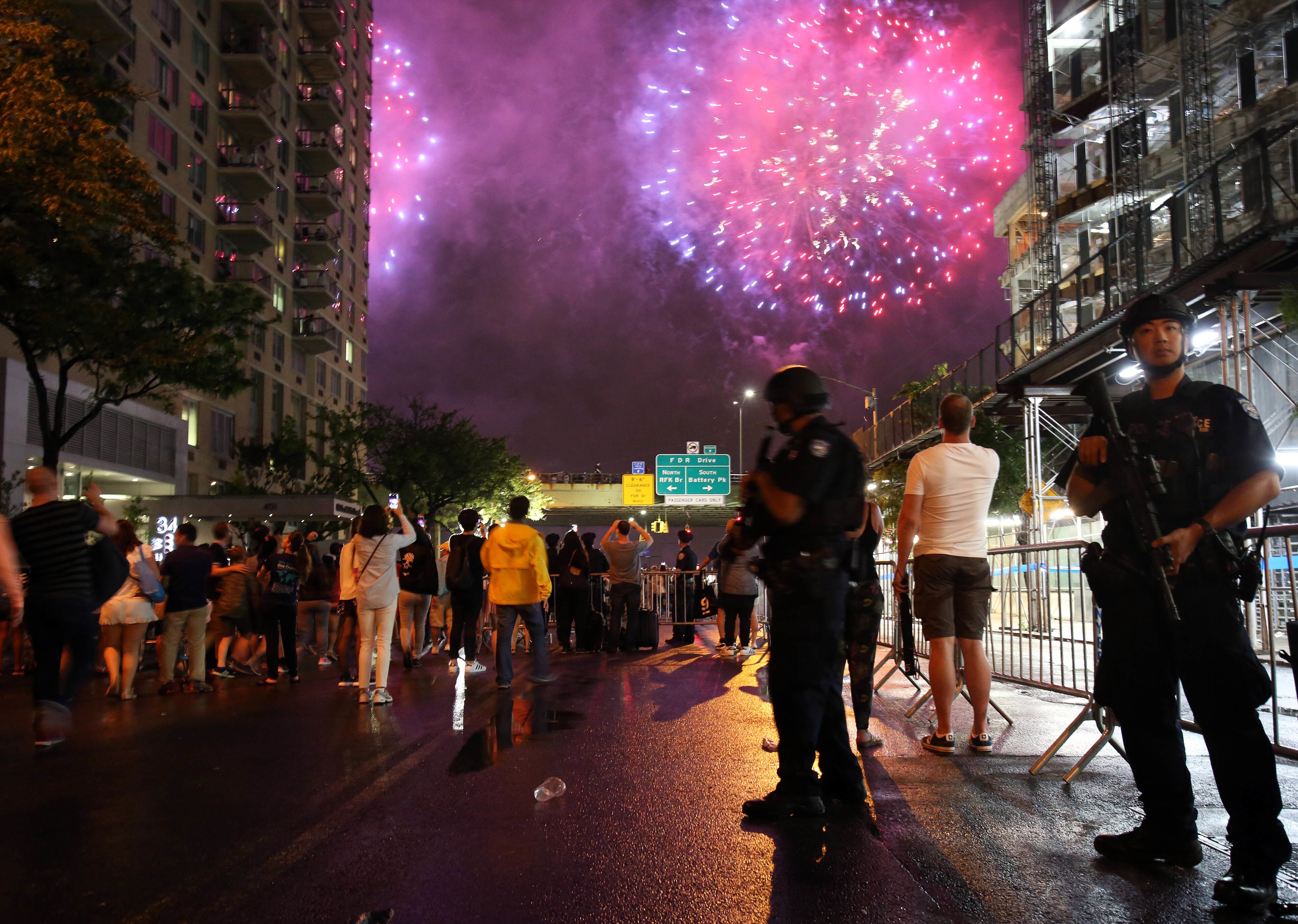 New York City counterterrorism police officers watch over spectators watching the Fourth of July fireworks, Monday, July 4, 2016, along the East River on the FDR Drive in New York. (AP Photo/Adam Hunger)