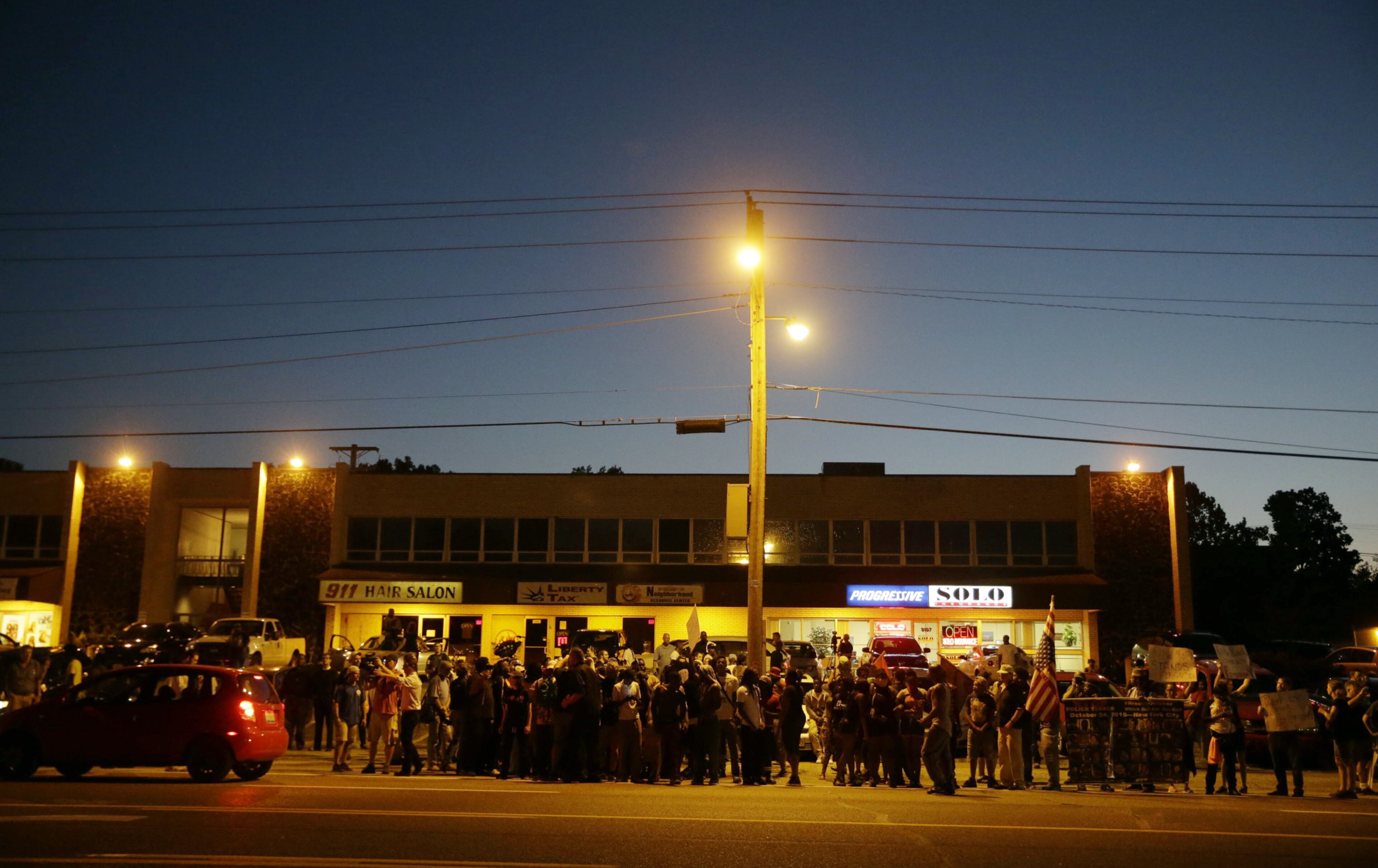 A crowd gathers along West Florissant Avenue on Aug. 10, 2015, in Ferguson, Mo. Ferguson was a community on edge again Monday, a day after a protest marking the anniversary of Michael Brown's death was punctuated with gunshots.