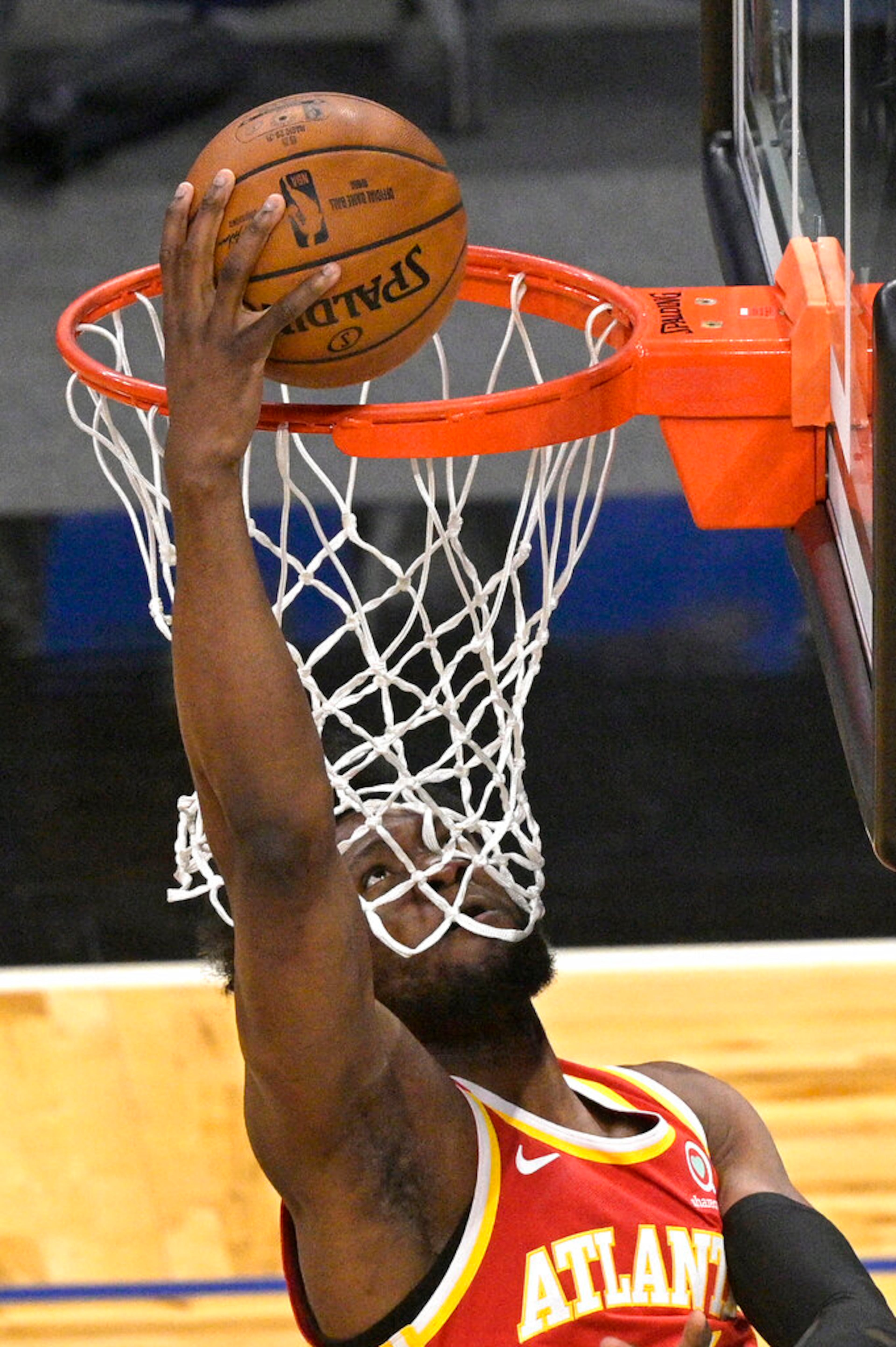 Atlanta Hawks forward Bruno Fernando scores from under the basket during the first half of the team's NBA basketball game against the Orlando Magic, Wednesday, March 3, 2021, in Orlando, Fla. (AP Photo/Phelan M. Ebenhack)