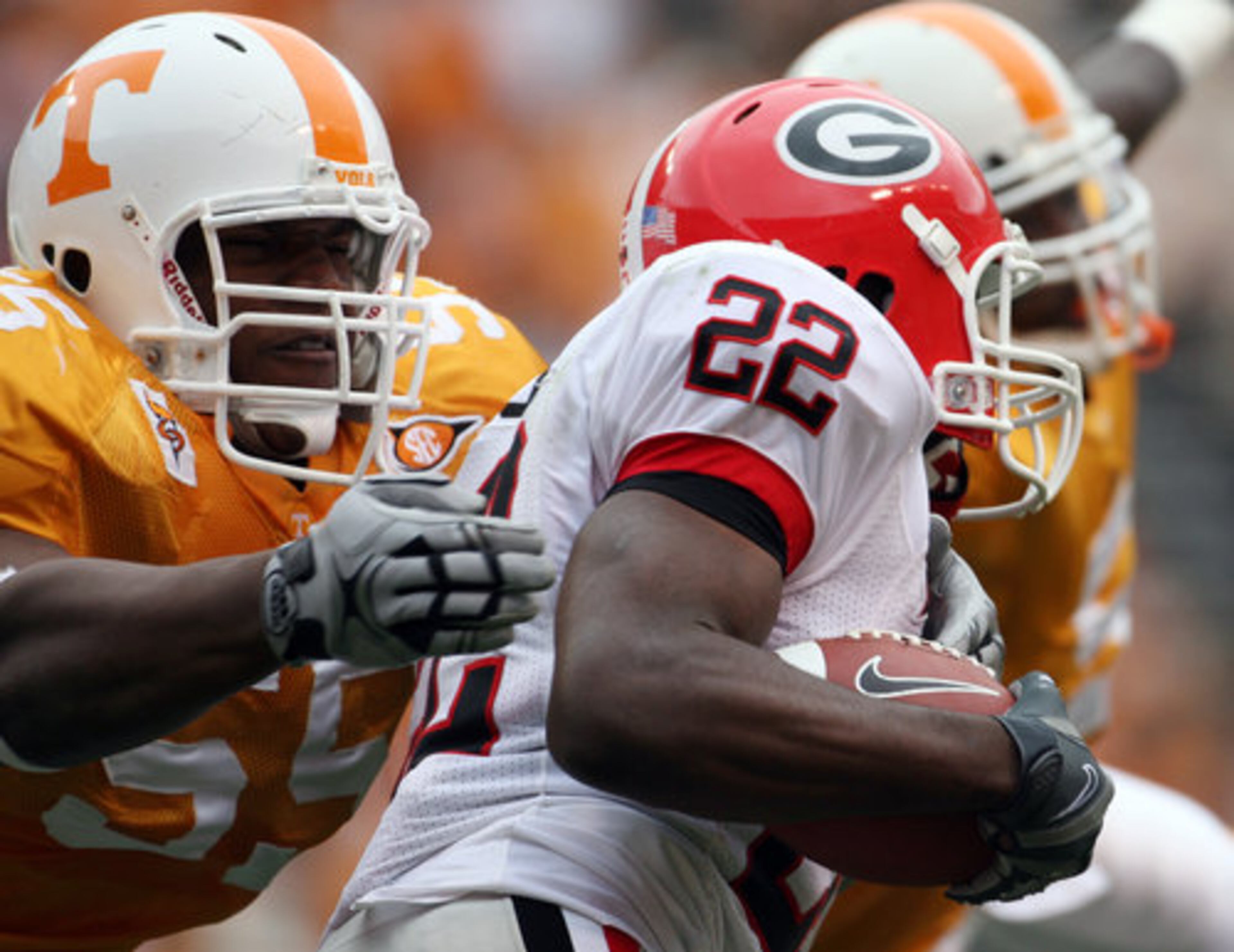UGA RB Richard Samuel tries to escape the tackle attempt of Tennessee's Dan Williams.