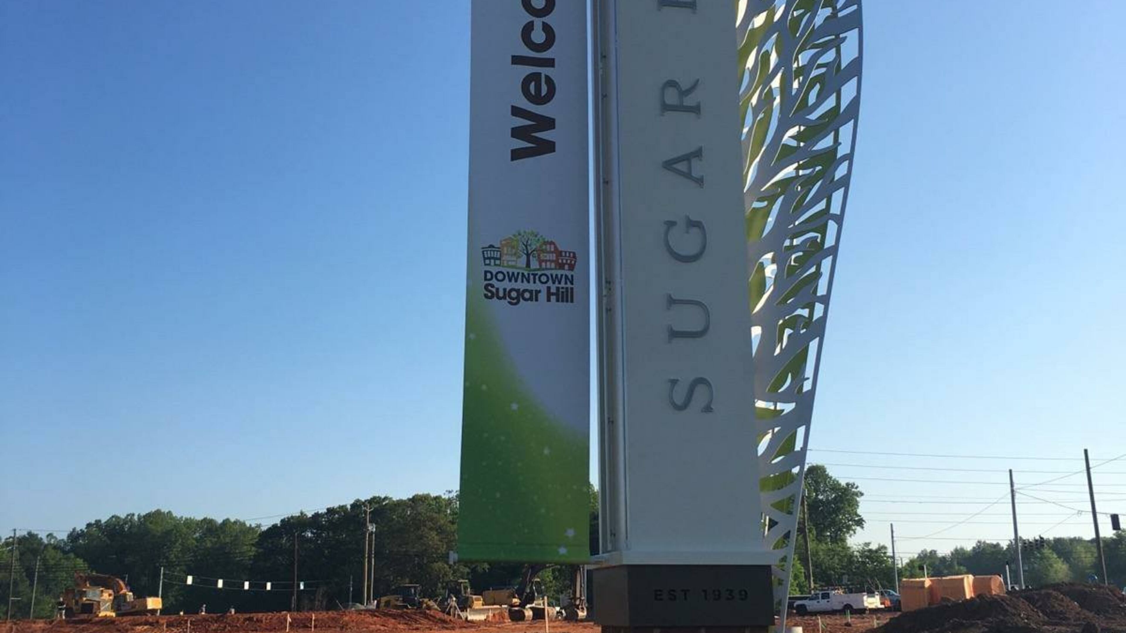 Sugar Hill unveils the city’s latest gateway signage. Visible behind the sign is construction for a new RaceTrac gas station. Courtesy City of Sugar Hill