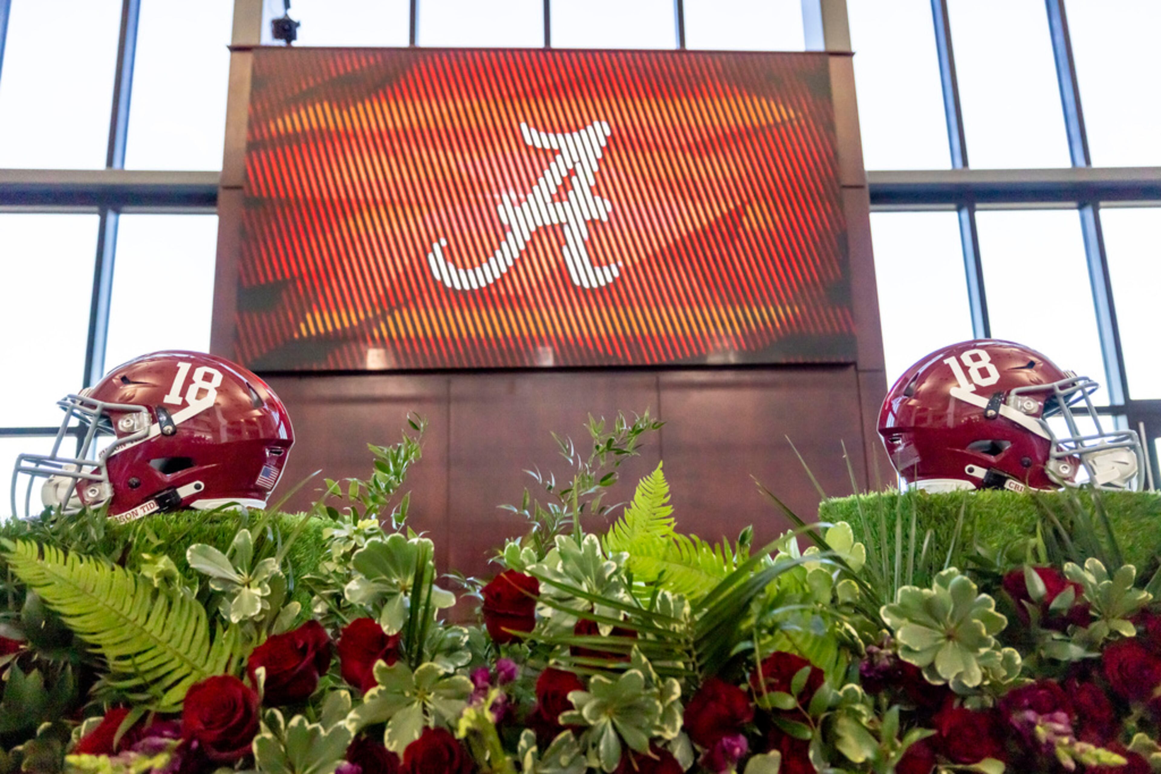 Alabama helmets flank the stage before new Alabama football head coach Kalen DeBoer's introductory speech at Bryant-Denny Stadium, Saturday, Jan. 13, 2024, in Tuscaloosa, Ala. DeBoer is replacing the recently retired Nick Saban. (AP Photo/Vasha Hunt)