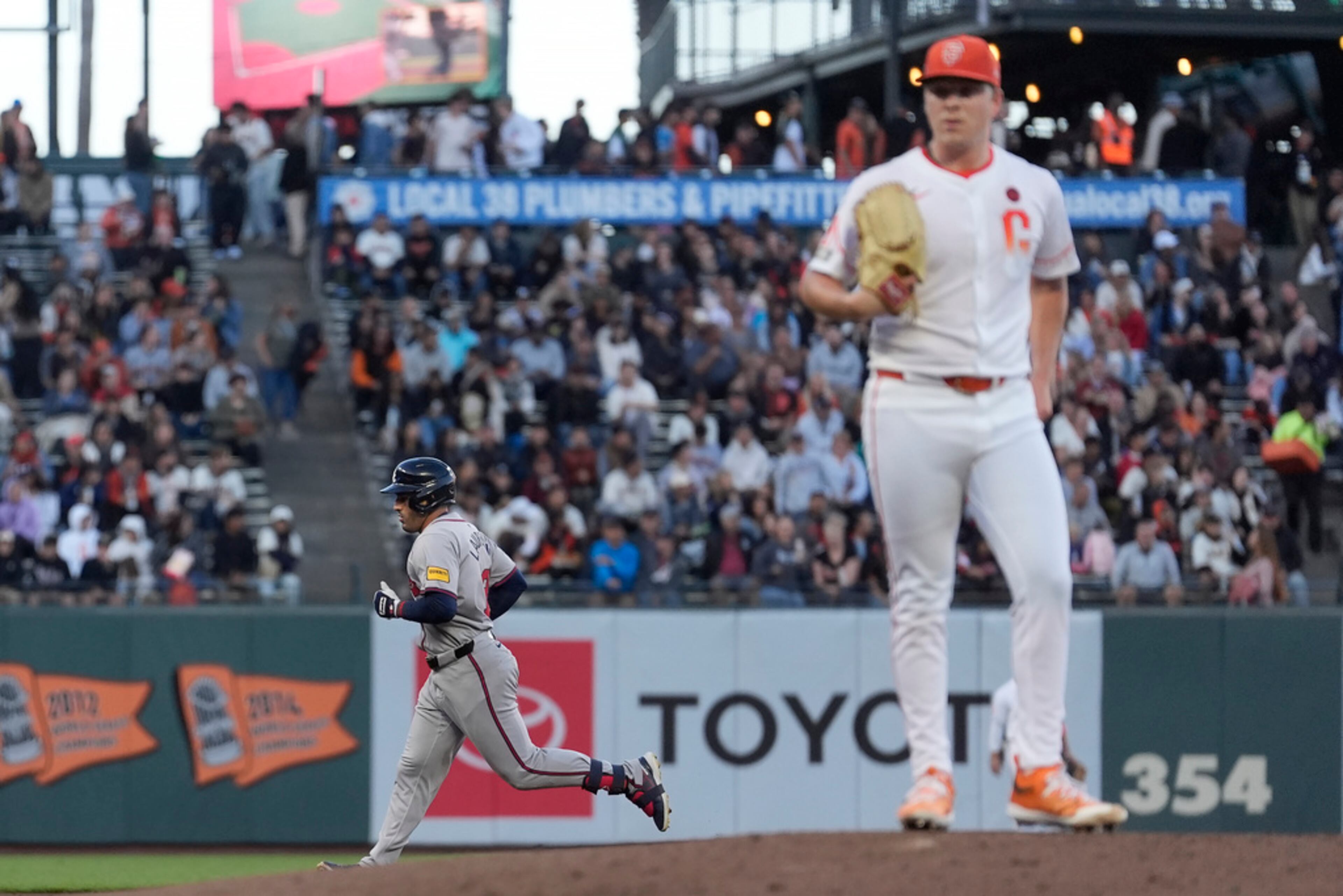 Atlanta Braves' Ramón Laureano, left rear, runs the bases after hitting a home run off of San Francisco Giants pitcher Kyle Harrison, foreground, during the second inning of a baseball game in San Francisco, Tuesday, Aug. 13, 2024. (AP Photo/Jeff Chiu)